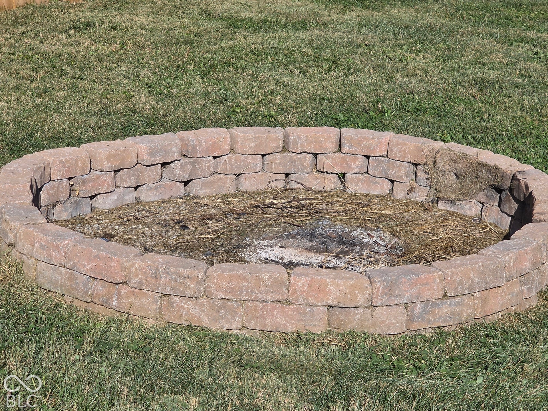 Circular fire pit featuring stacked masonry block construction