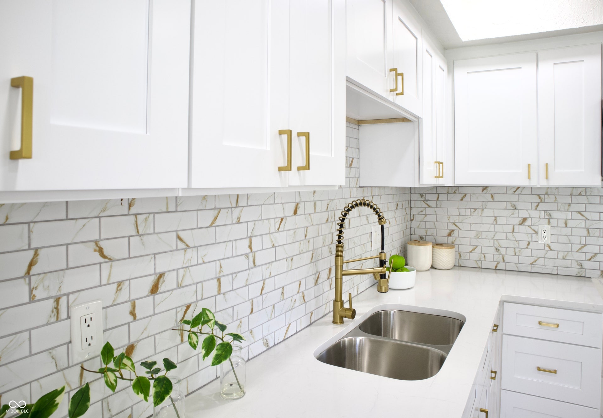 474 N Randolph Street, Indianapolis, IN 46201 Designer backsplash, light stone countertops, and a gold pull-down faucet.
