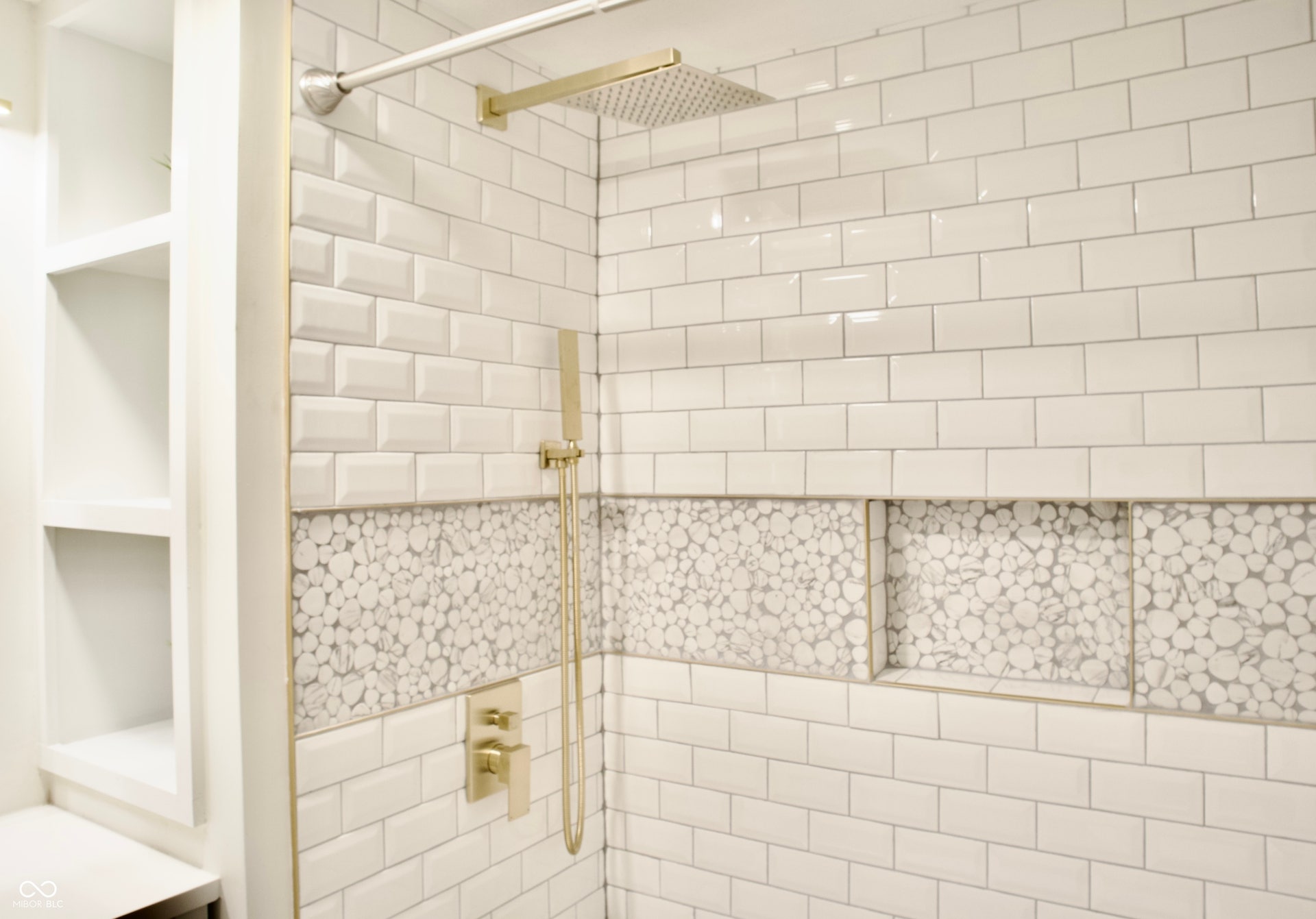 474 N Randolph Street, Indianapolis, IN 46201 Spa-style tiled shower with a gold rain showerhead and built-in niche.
