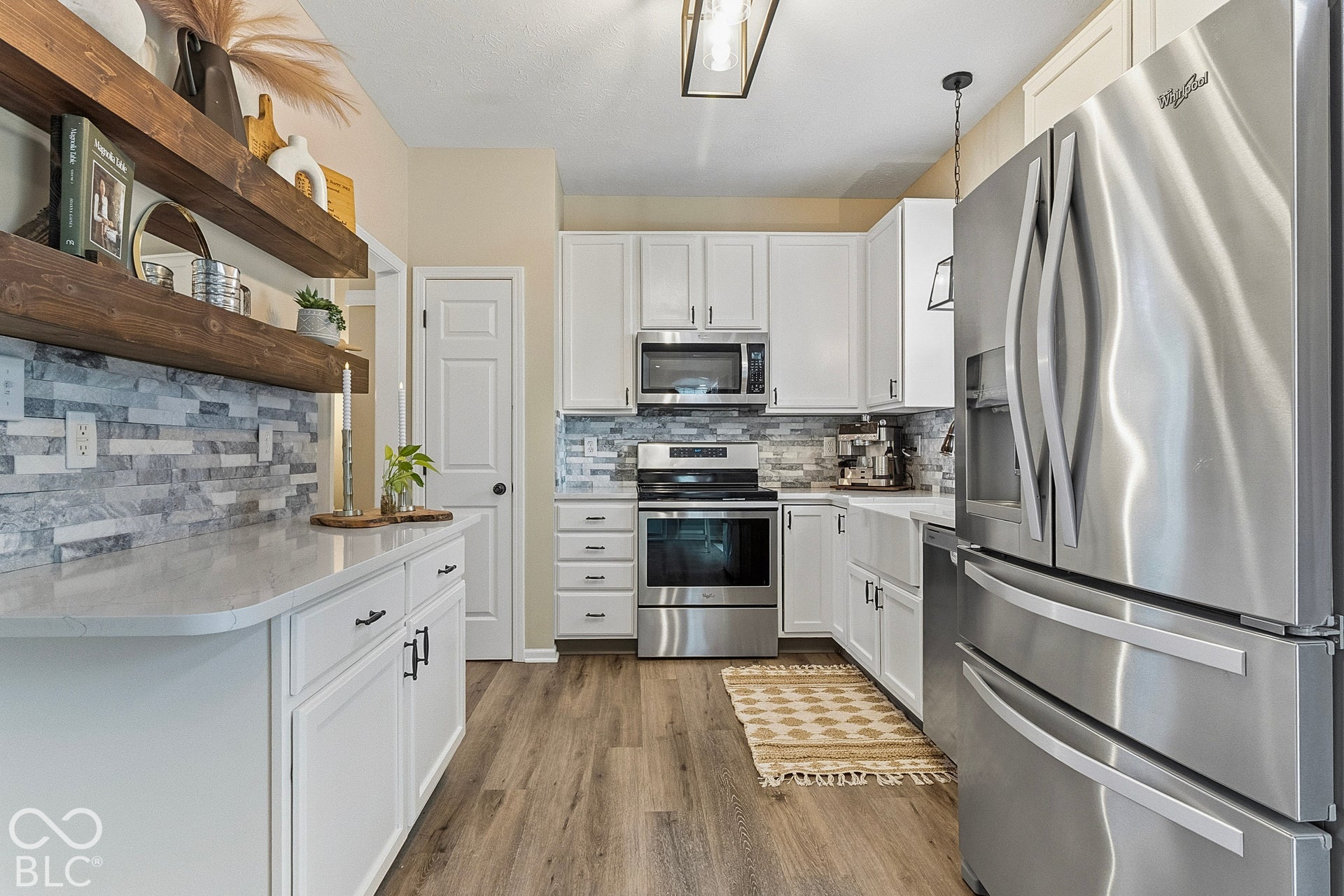 A beautifully updated kitchen designed for both everyday living and effortless entertaining. Bright white cabinetry, abundant counter space, and a practical layout provide excellent functionality, while stainless steel appliances and stylish tile acc
