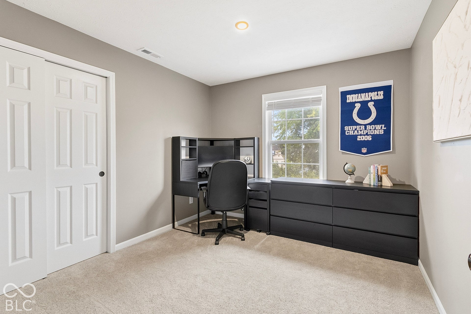 Bedroom 3: Bright and versatile third bedroom featuring neutral paint, plush carpeting, recessed lighting, and a large window providing abundant natural light.