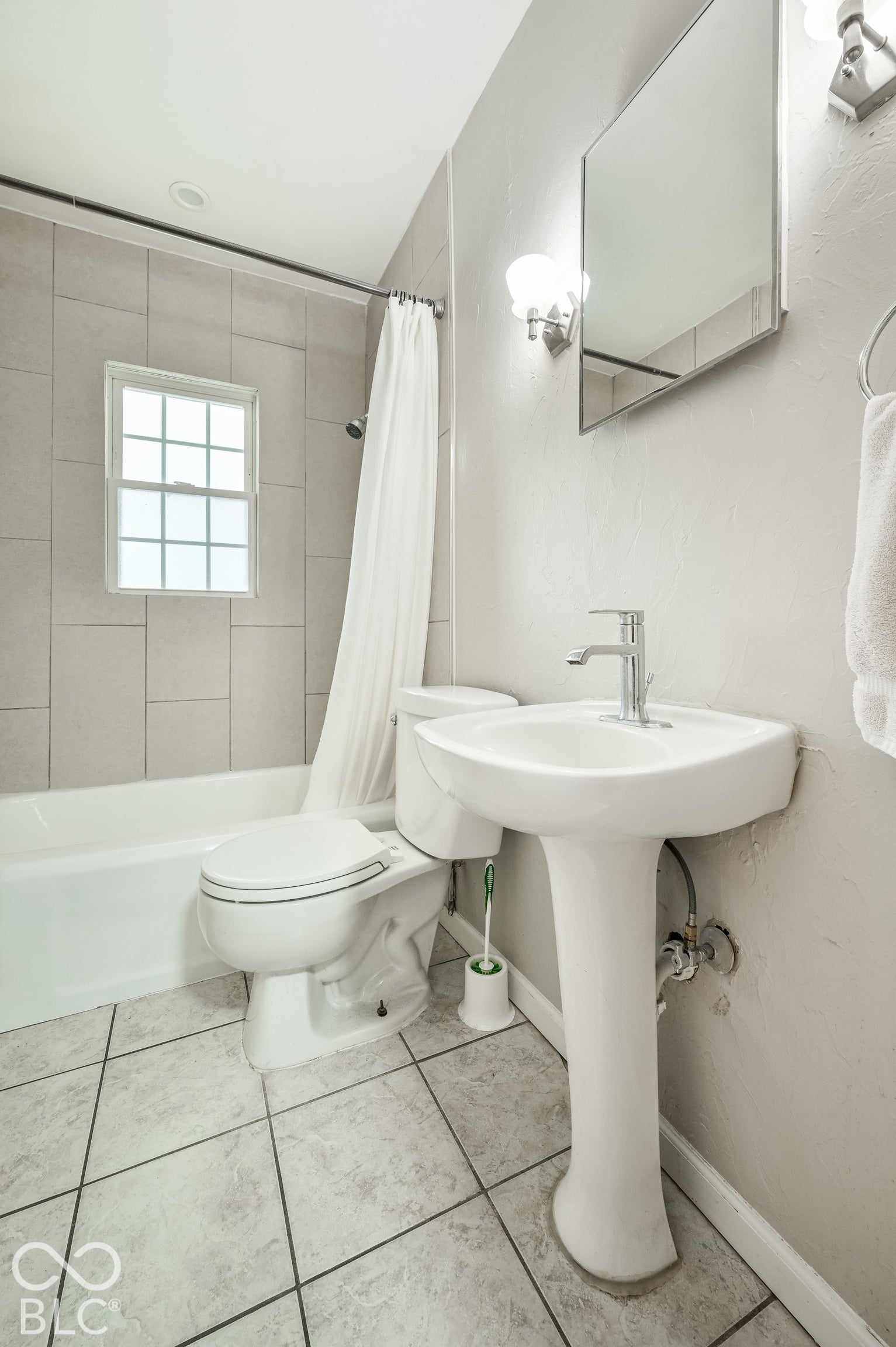 Full bathroom with a tile floor.
