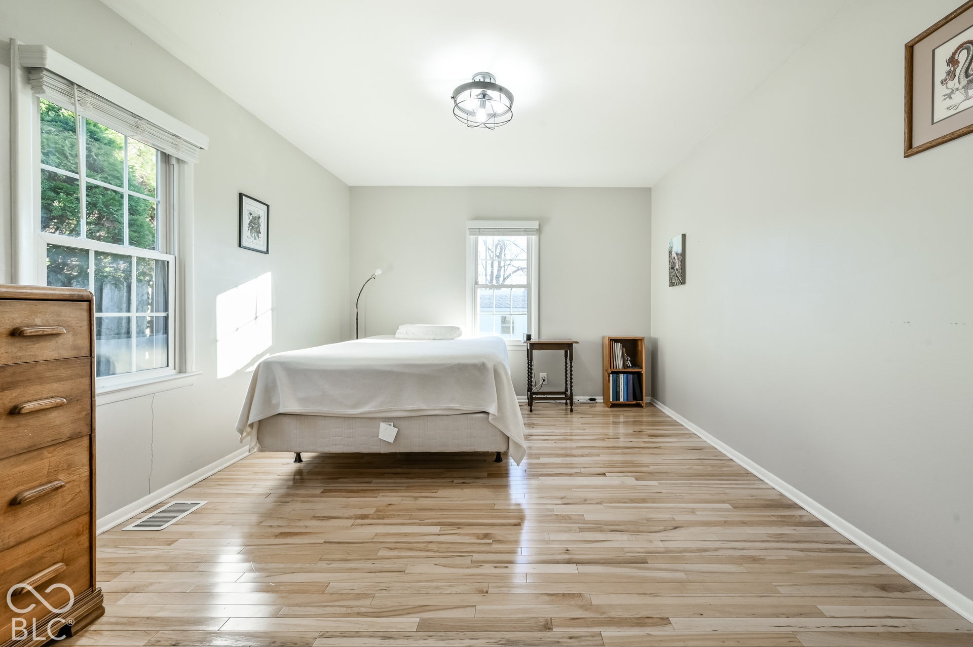 This bedroom as been used as the primary bedroom. It is spaious with hardwood floors