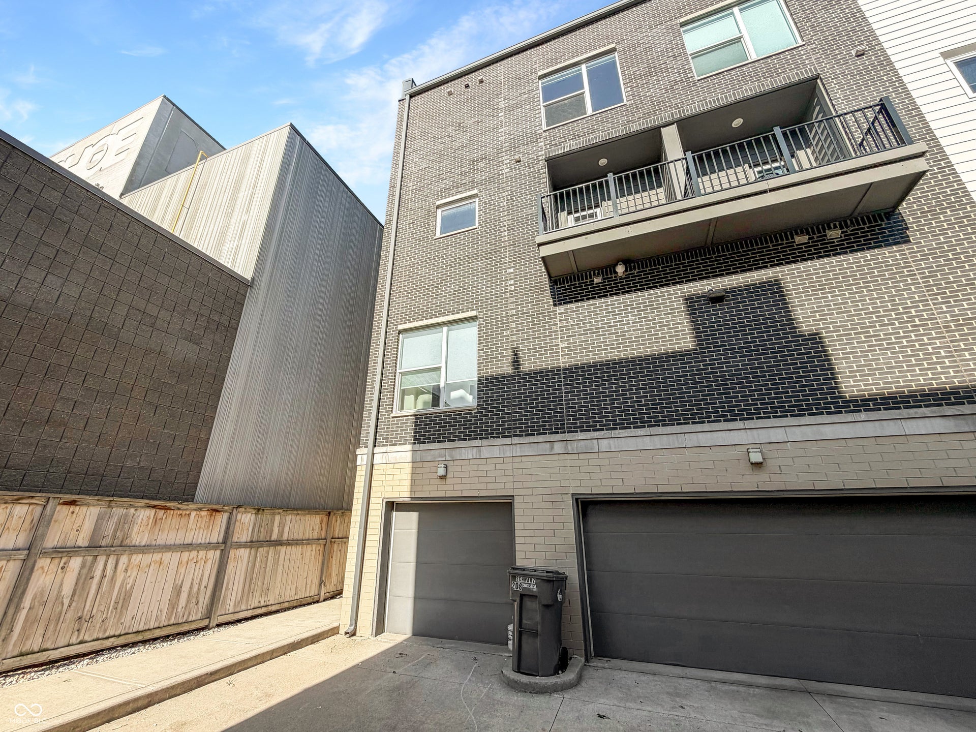 Contemporary multi-story exterior with dark brick and light brick accents