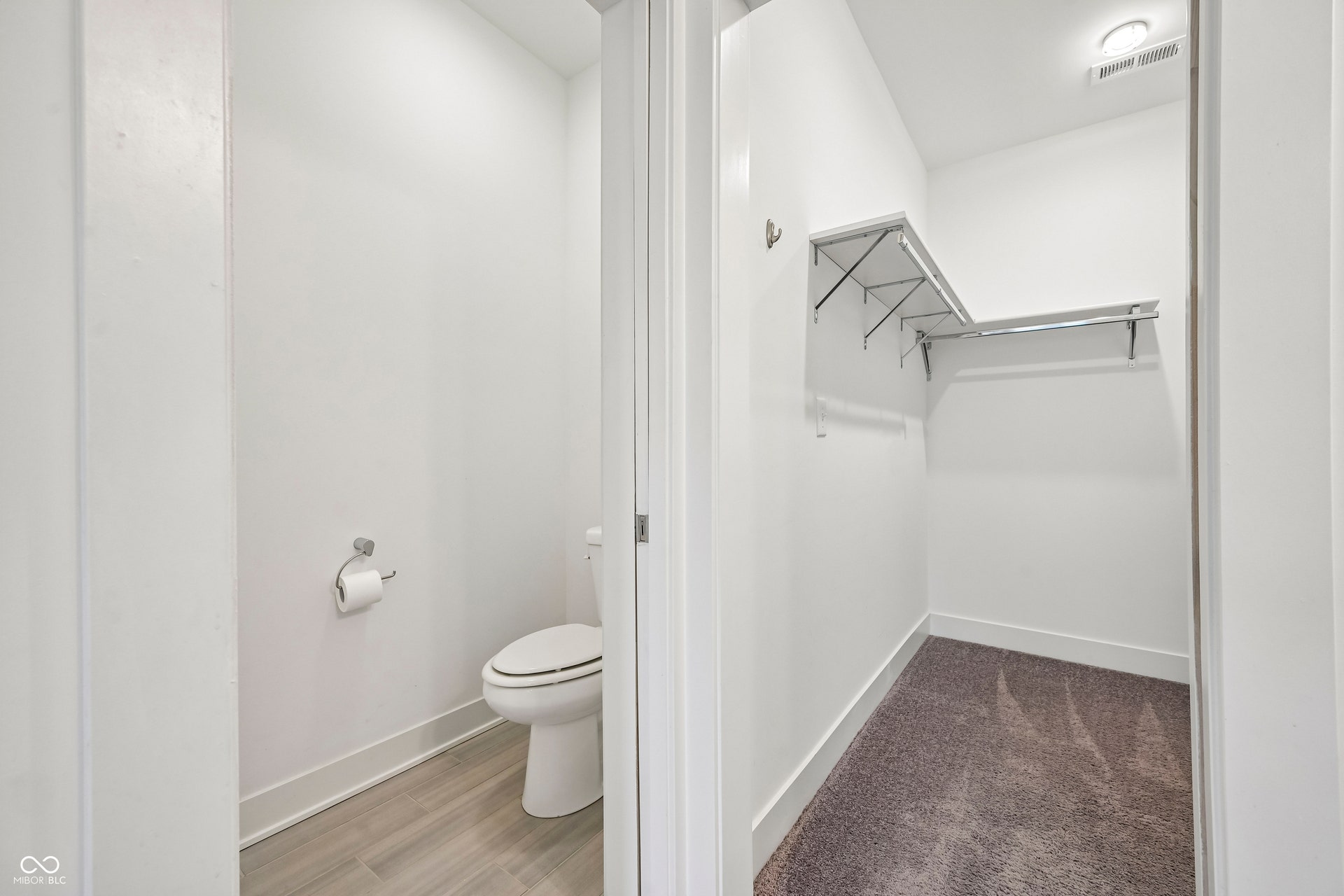 Dedicated water closet with wood-finish flooring