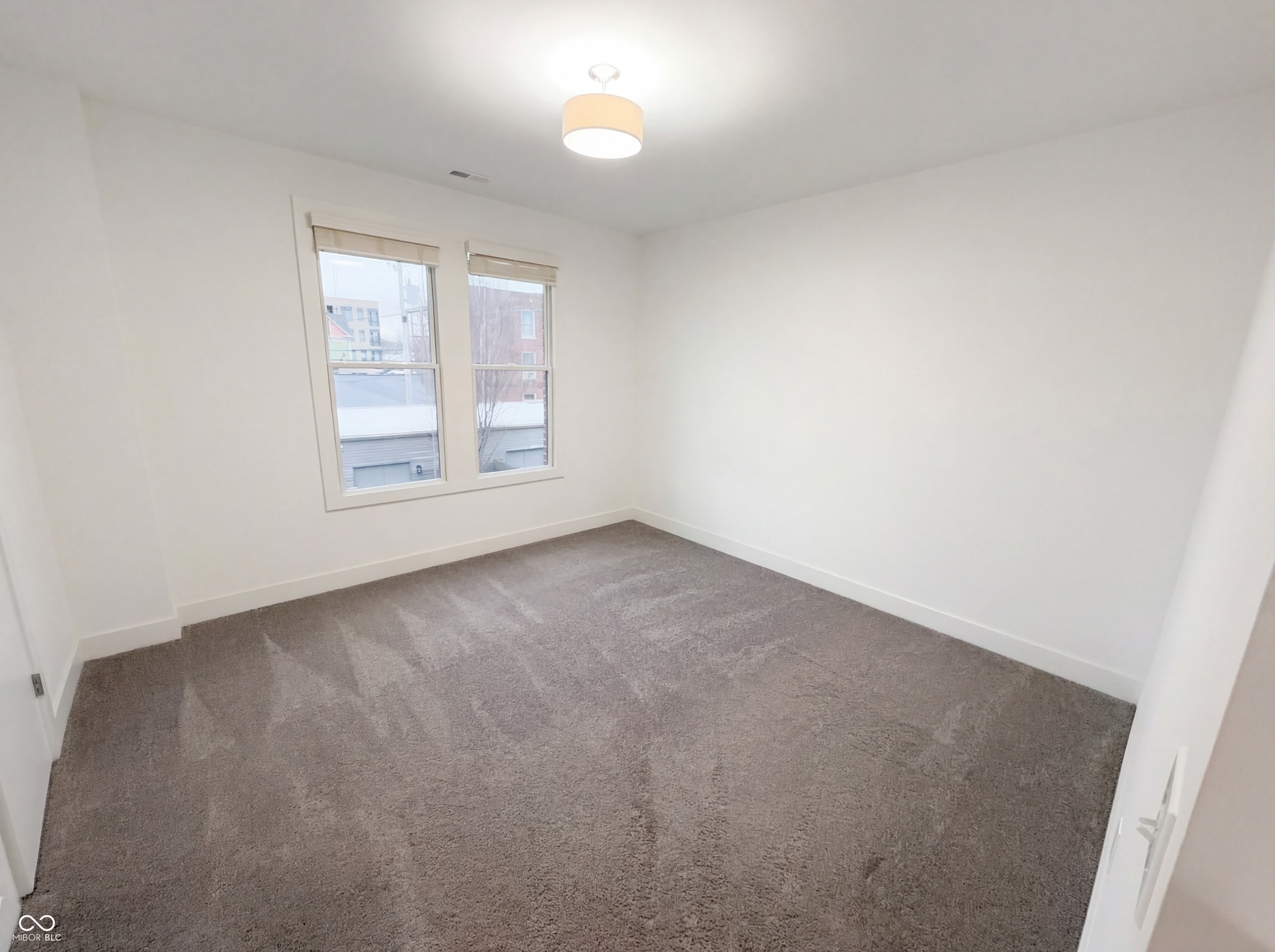 Room featuring gray carpeting, white walls, and white trim