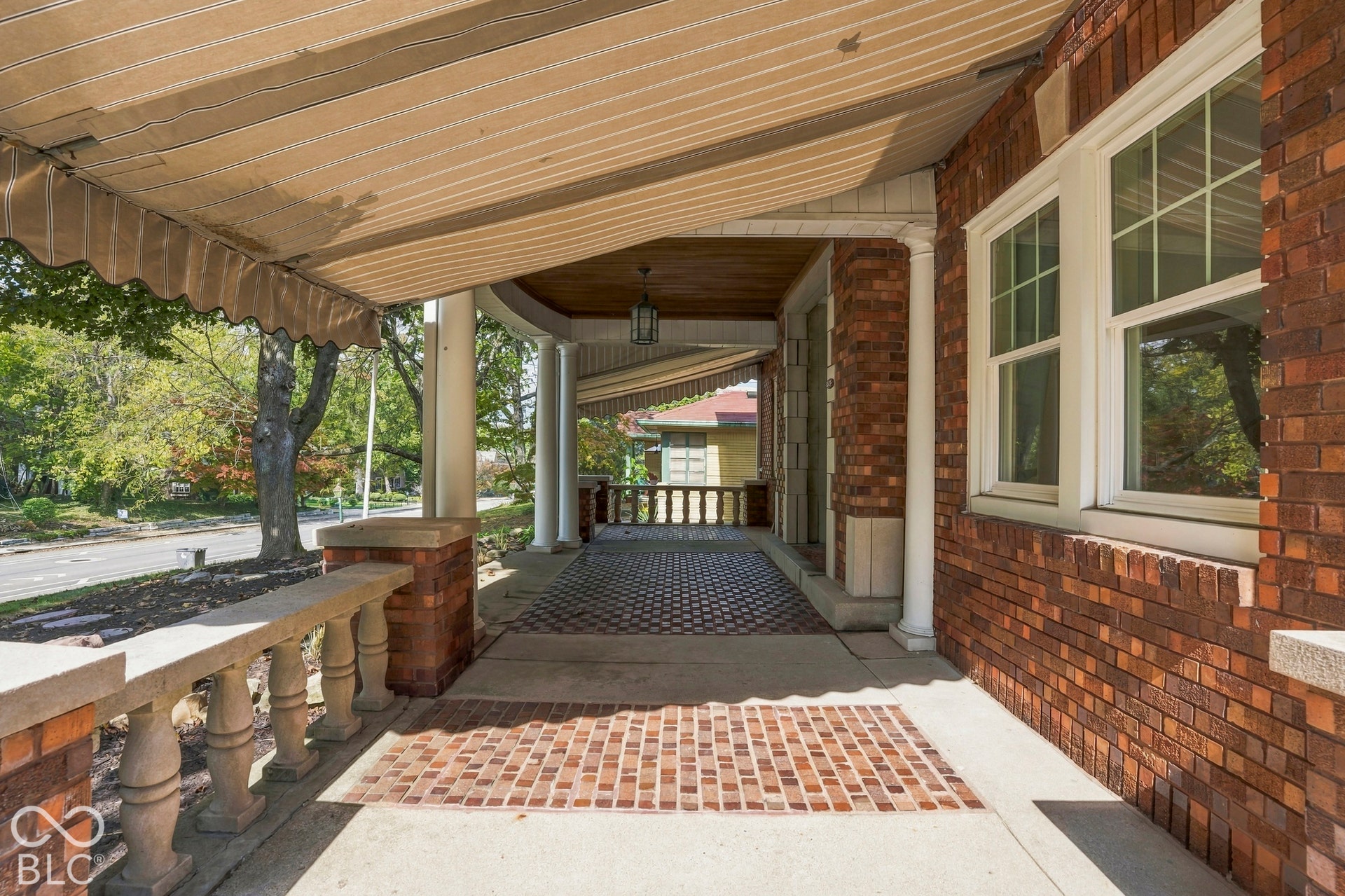 Gorgeous front porch, limestone balustrade, awning