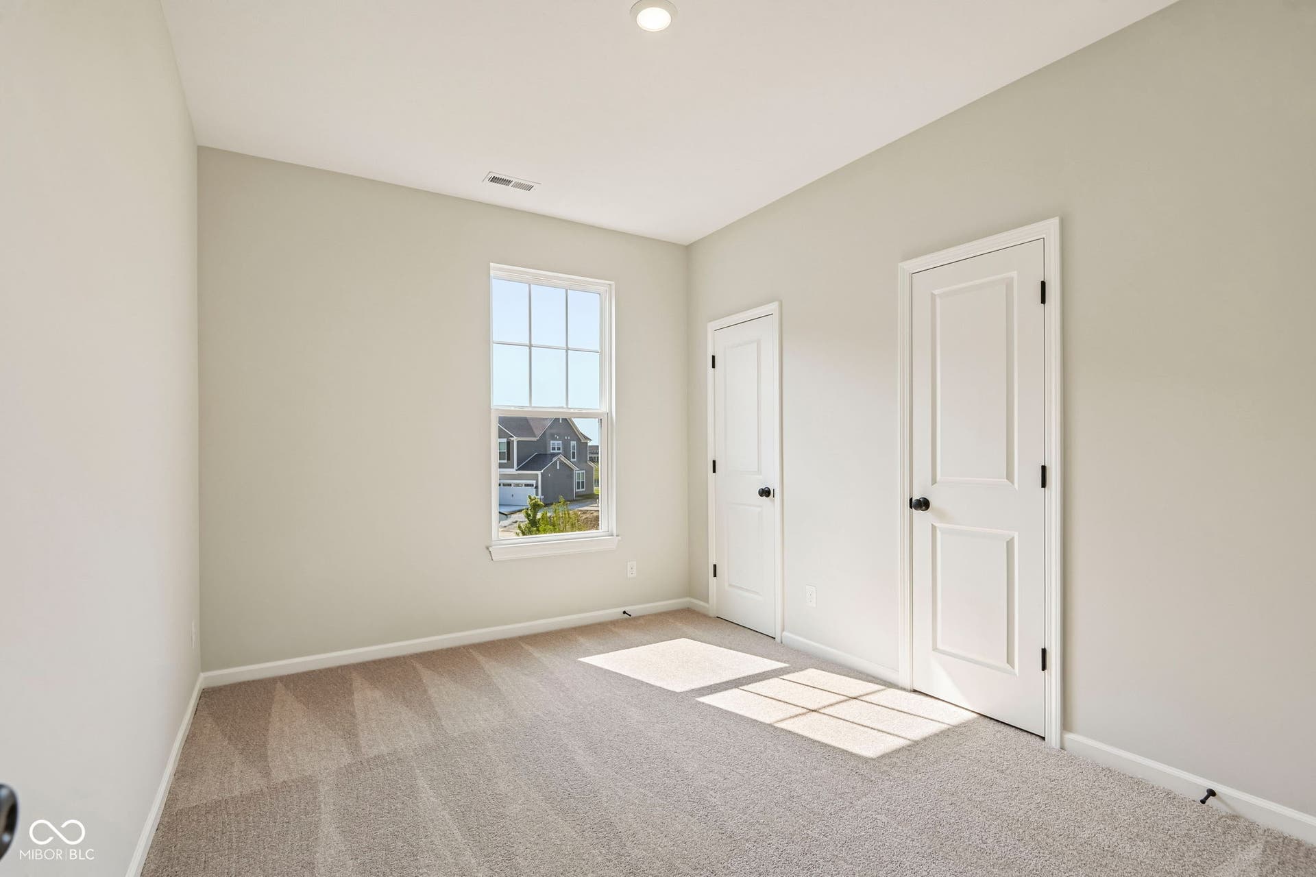 15691 Showdown Road, Noblesville, IN 46060 Carpeted room with neutral wall tones and a single window featuring grid patterns