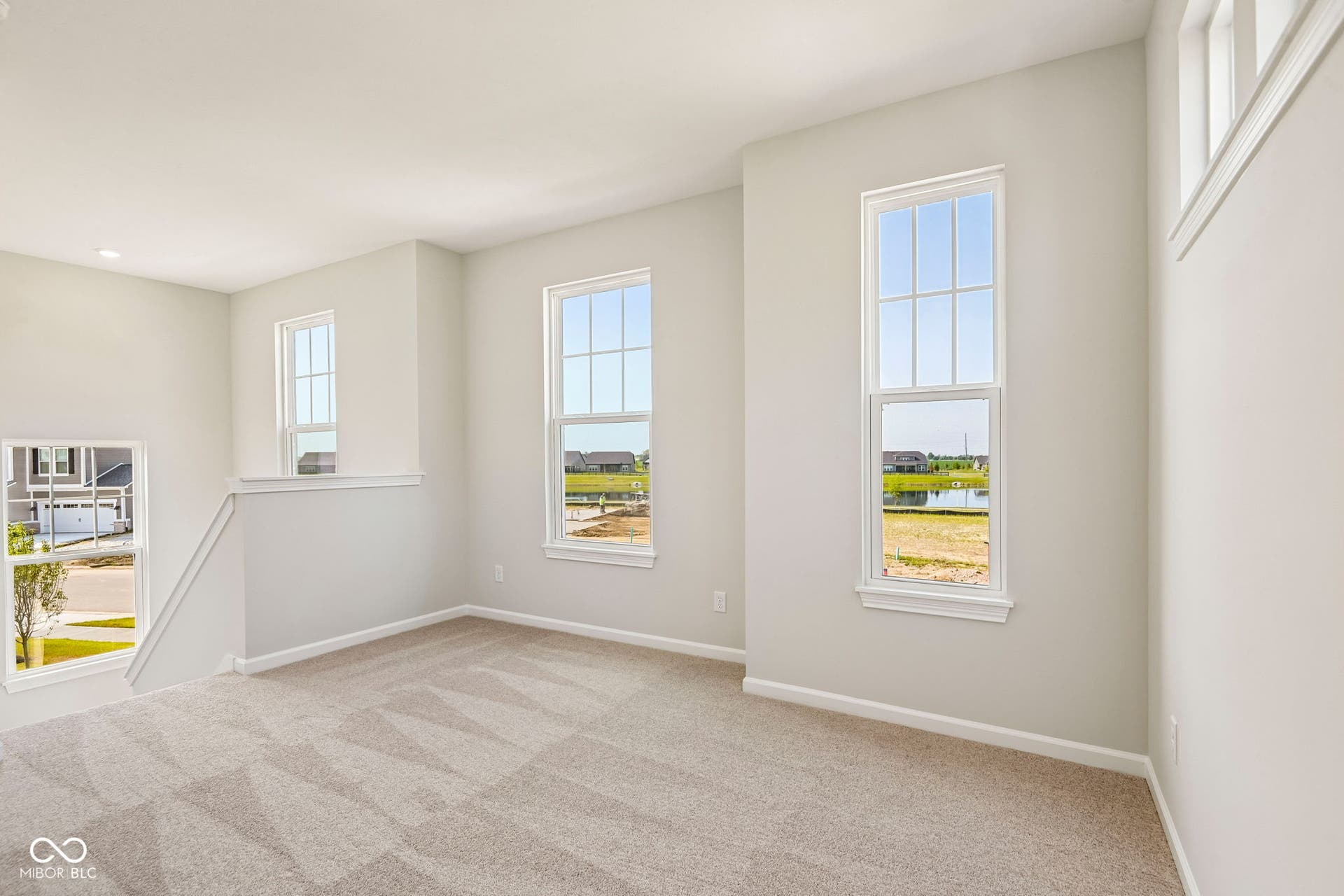 15691 Showdown Road, Noblesville, IN 46060 Carpeted room featuring multiple windows, recessed lighting, and white baseboards
