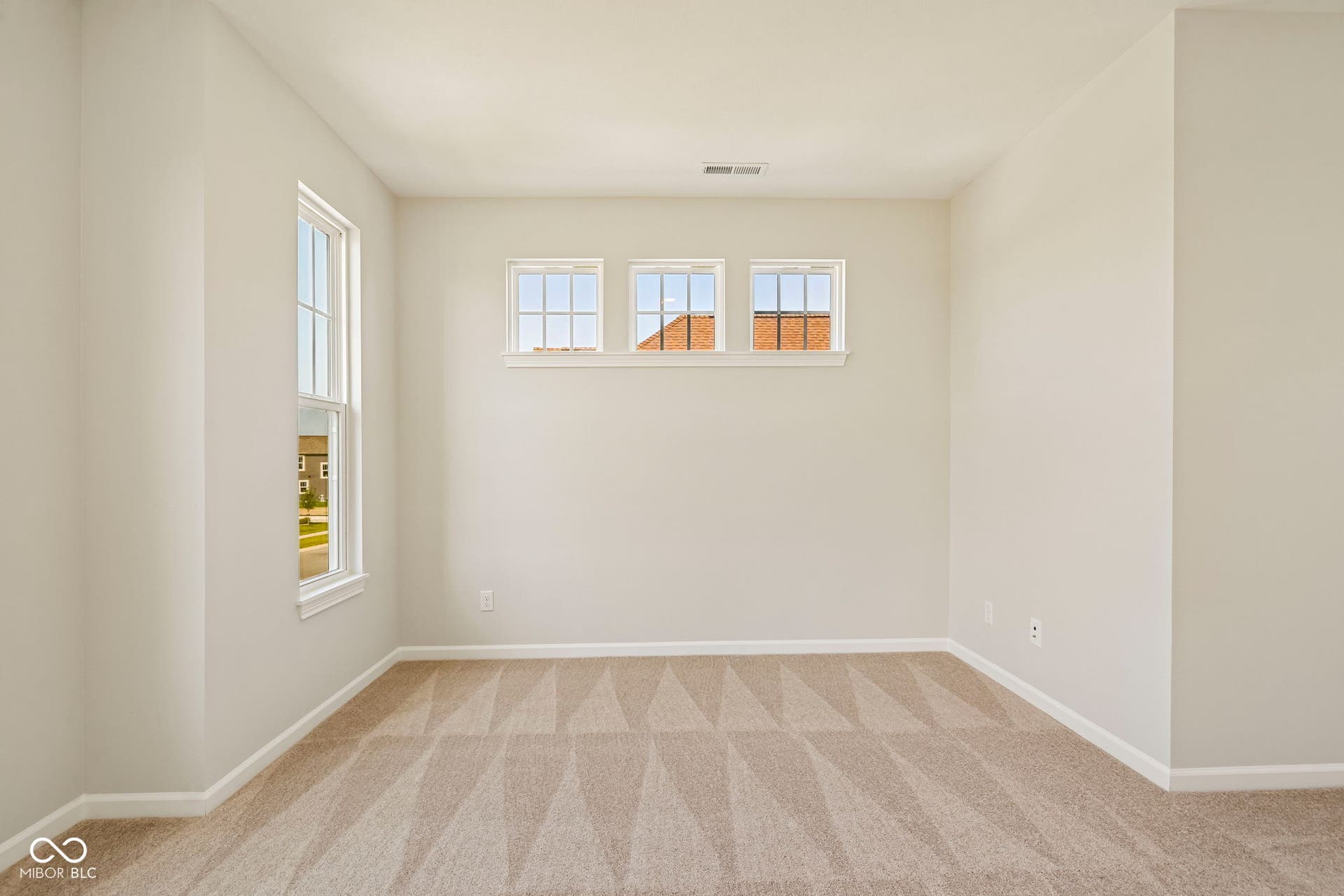 15691 Showdown Road, Noblesville, IN 46060 Neutral-toned room featuring a large vertical window and three horizontal transom windows