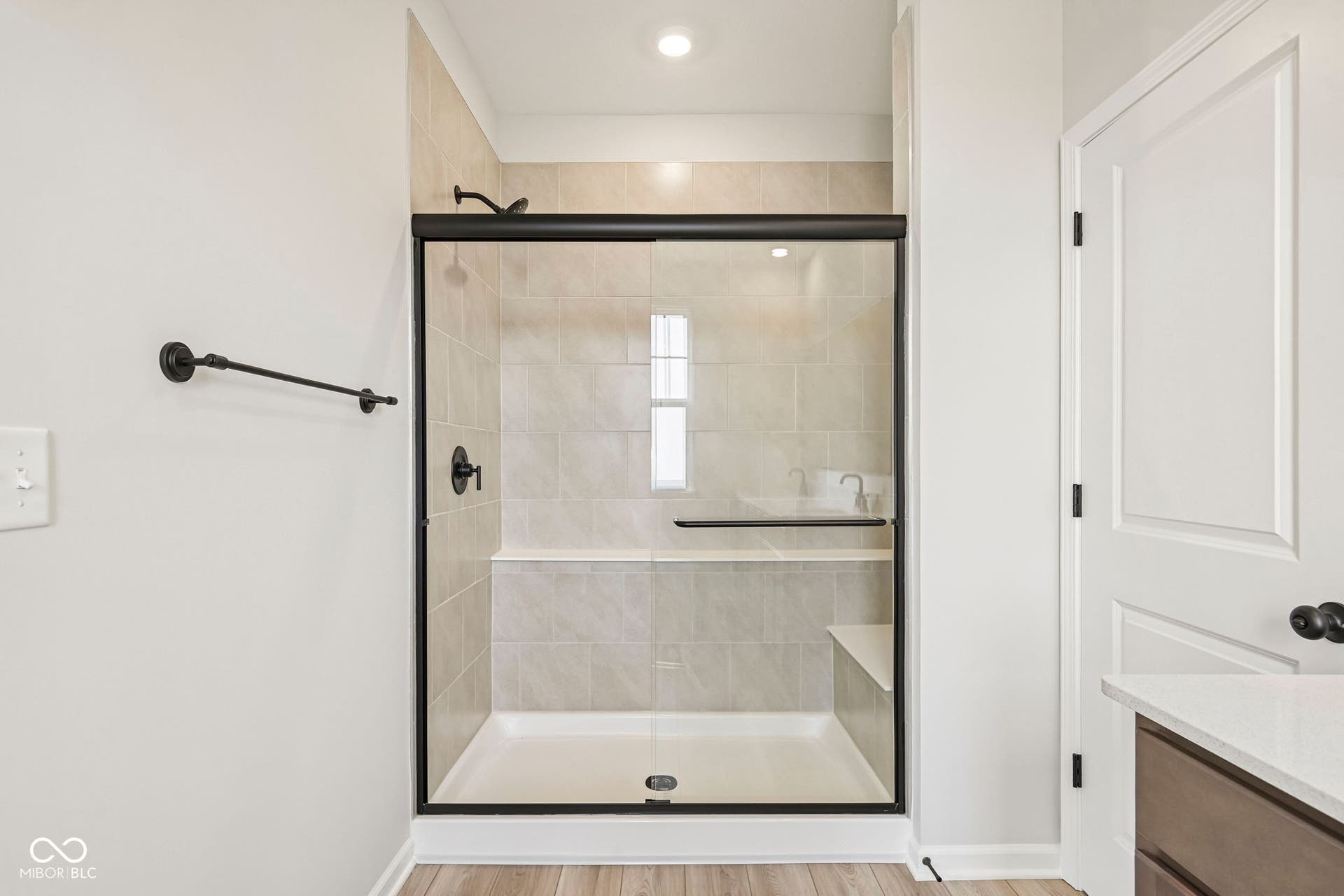 15691 Showdown Road, Noblesville, IN 46060 Walk-in shower with tiled walls, integrated bench, and matte black fixtures