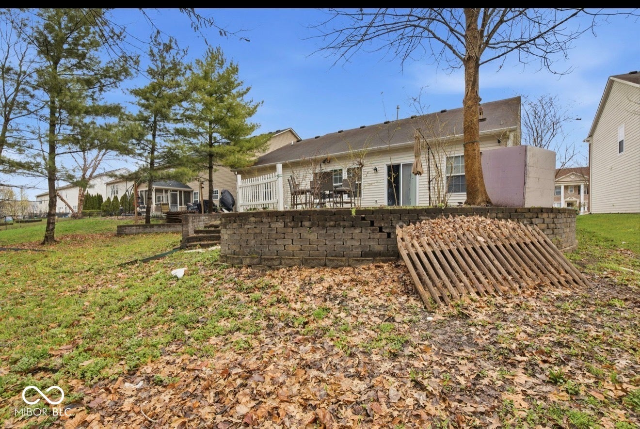 344 Legacy Boulevard, Greenwood, IN 46143 back of house featuring a patio area and a lawn