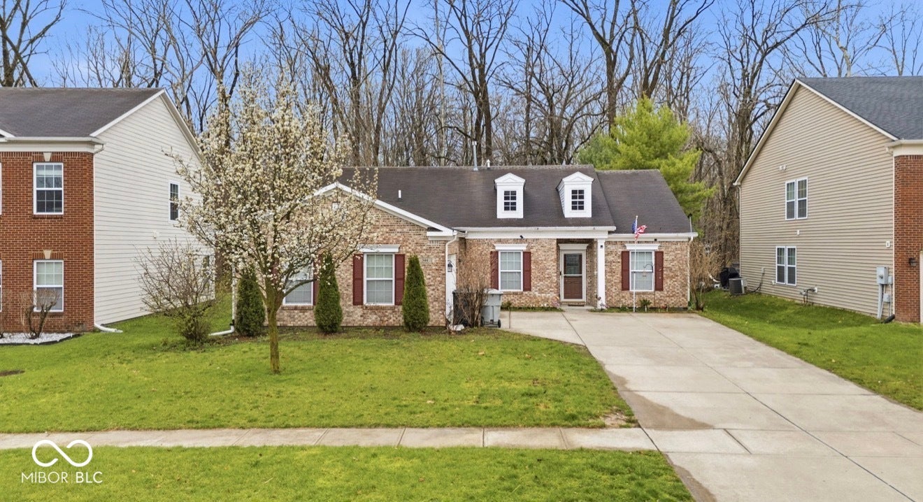 344 Legacy Boulevard, Greenwood, IN 46143 cape cod-style house featuring brick siding, concrete driveway, a front lawn, and a shingled roof