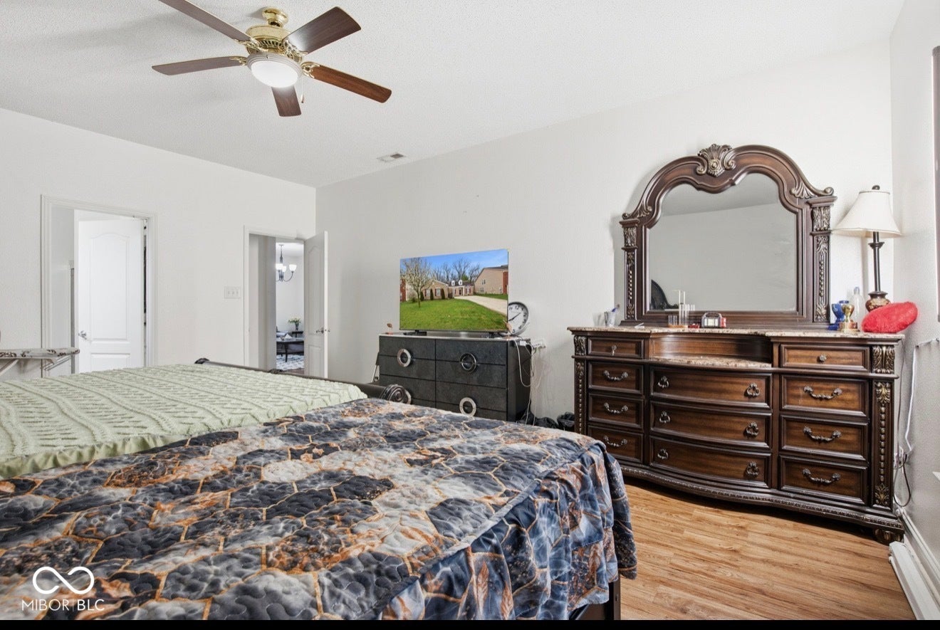 344 Legacy Boulevard, Greenwood, IN 46143 bedroom featuring light wood-type flooring and ceiling fan