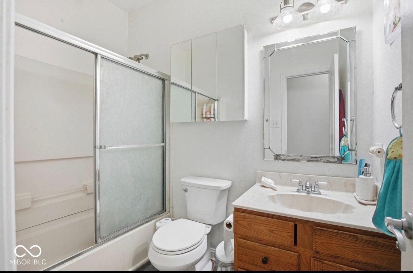344 Legacy Boulevard, Greenwood, IN 46143 bathroom with vanity and enclosed tub / shower combo