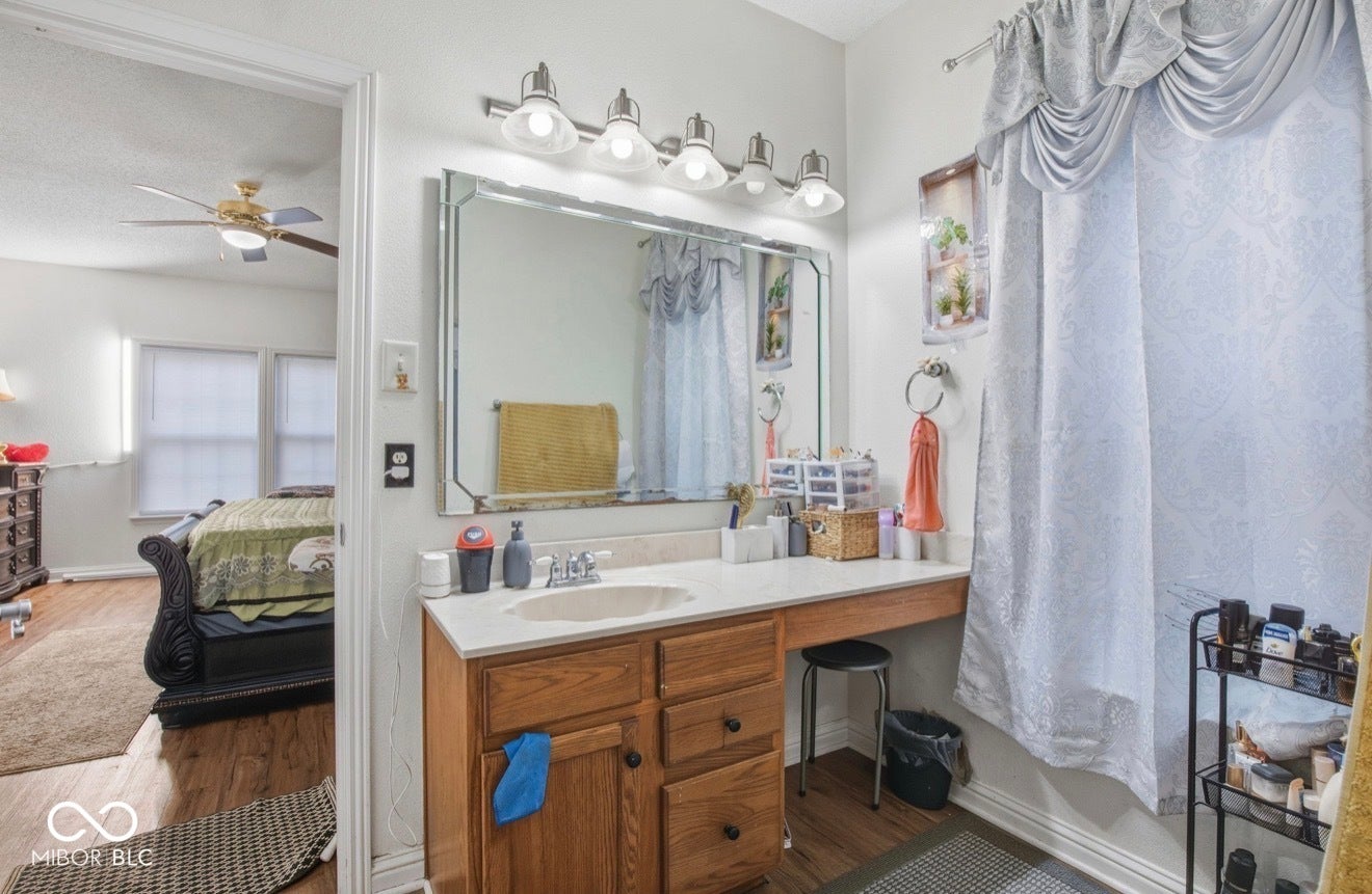 344 Legacy Boulevard, Greenwood, IN 46143 ensuite bathroom with vanity, wood finished floors, and ceiling fan