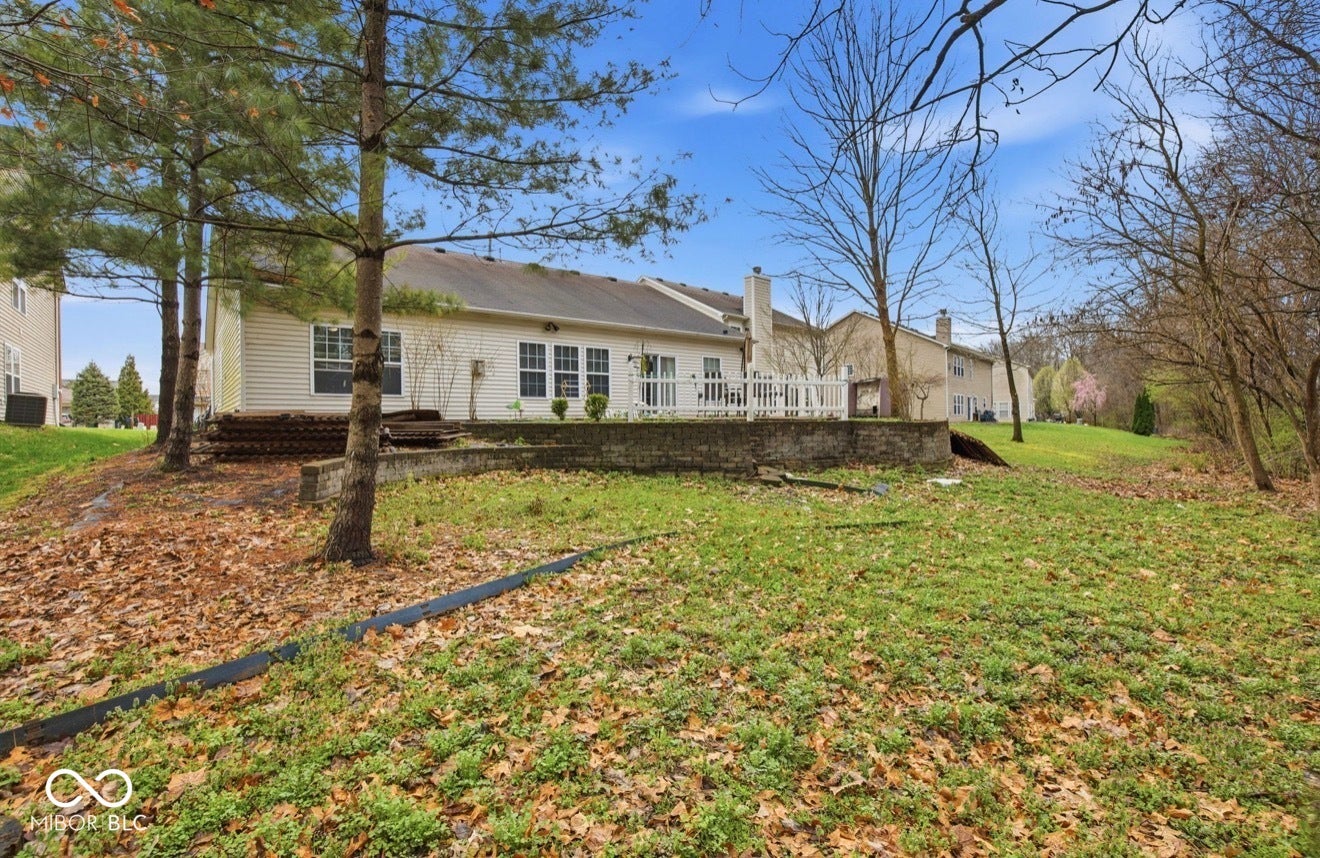 344 Legacy Boulevard, Greenwood, IN 46143 back of house featuring a lawn and a chimney