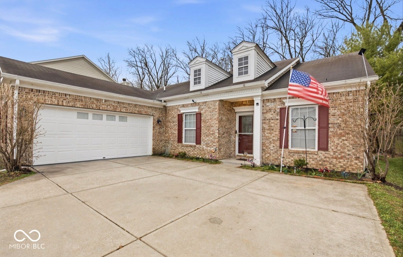 344 Legacy Boulevard, Greenwood, IN 46143 cape cod house with driveway, brick siding, and an attached garage