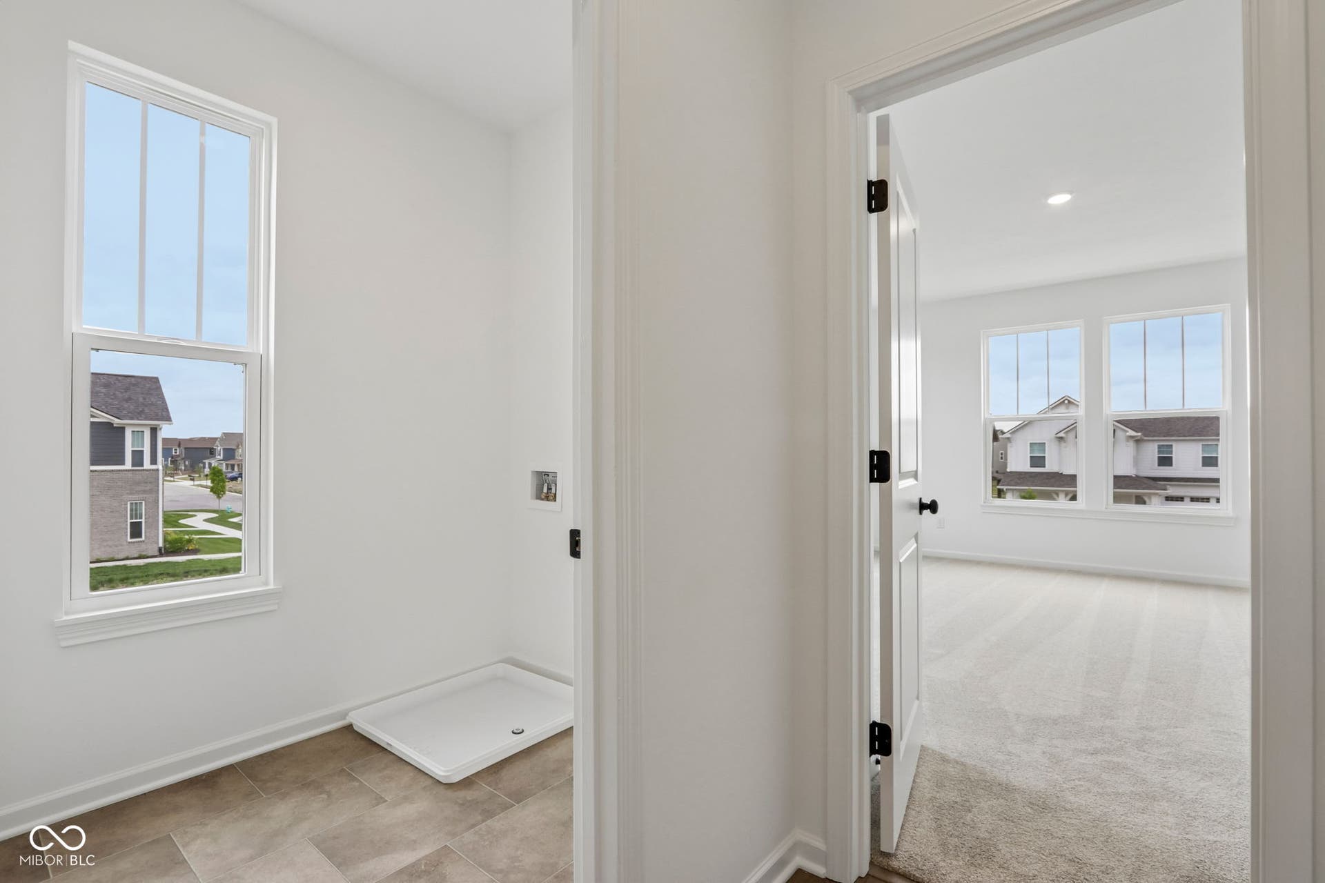 5748 Arcade Boulevard, McCordsville, IN 46055 Utility room featuring a single-hung window, durable tile flooring, and appliance hookups