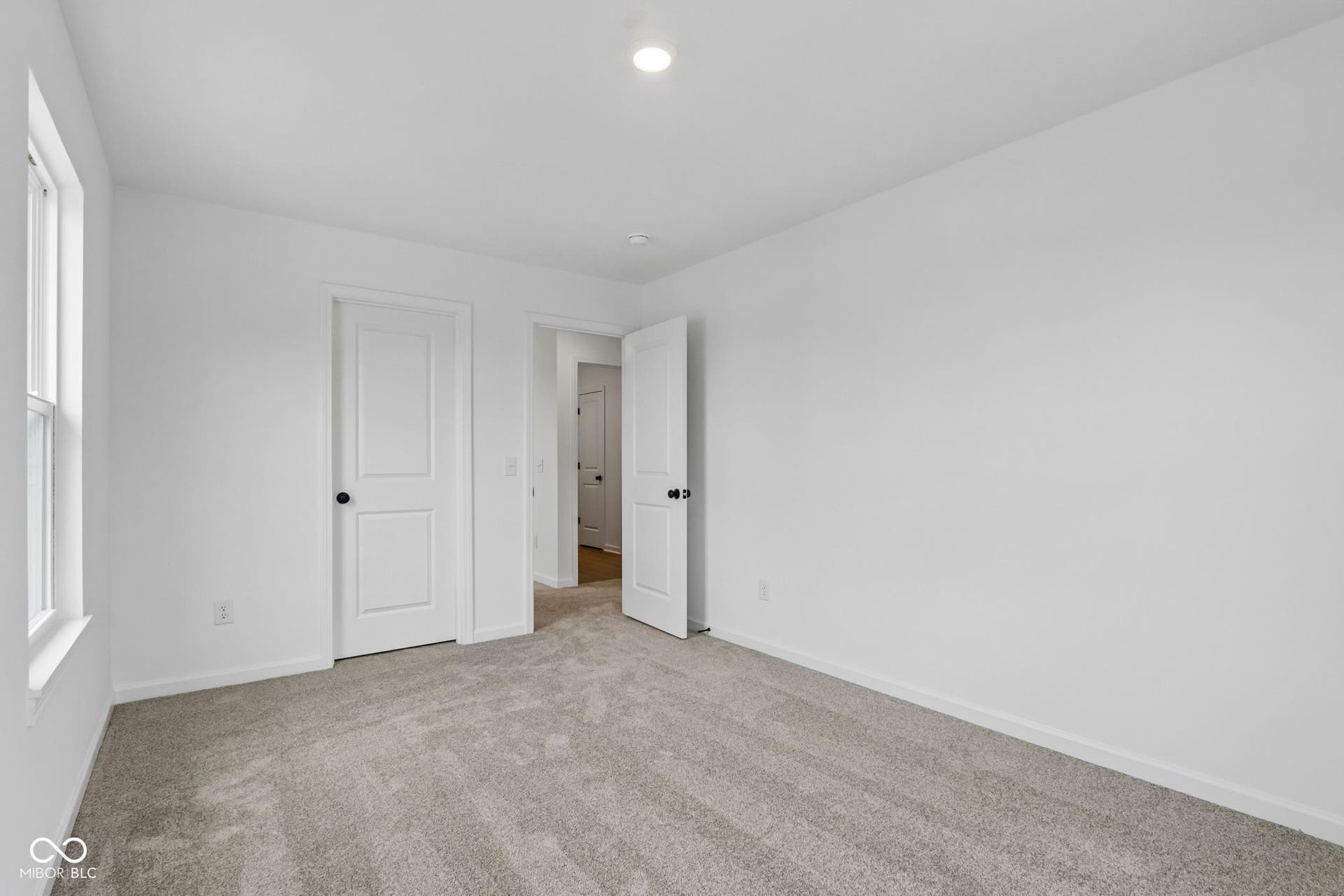 5748 Arcade Boulevard, McCordsville, IN 46055 Carpeted room featuring crisp white walls, a single window, and multiple interior doors with matte black hardware