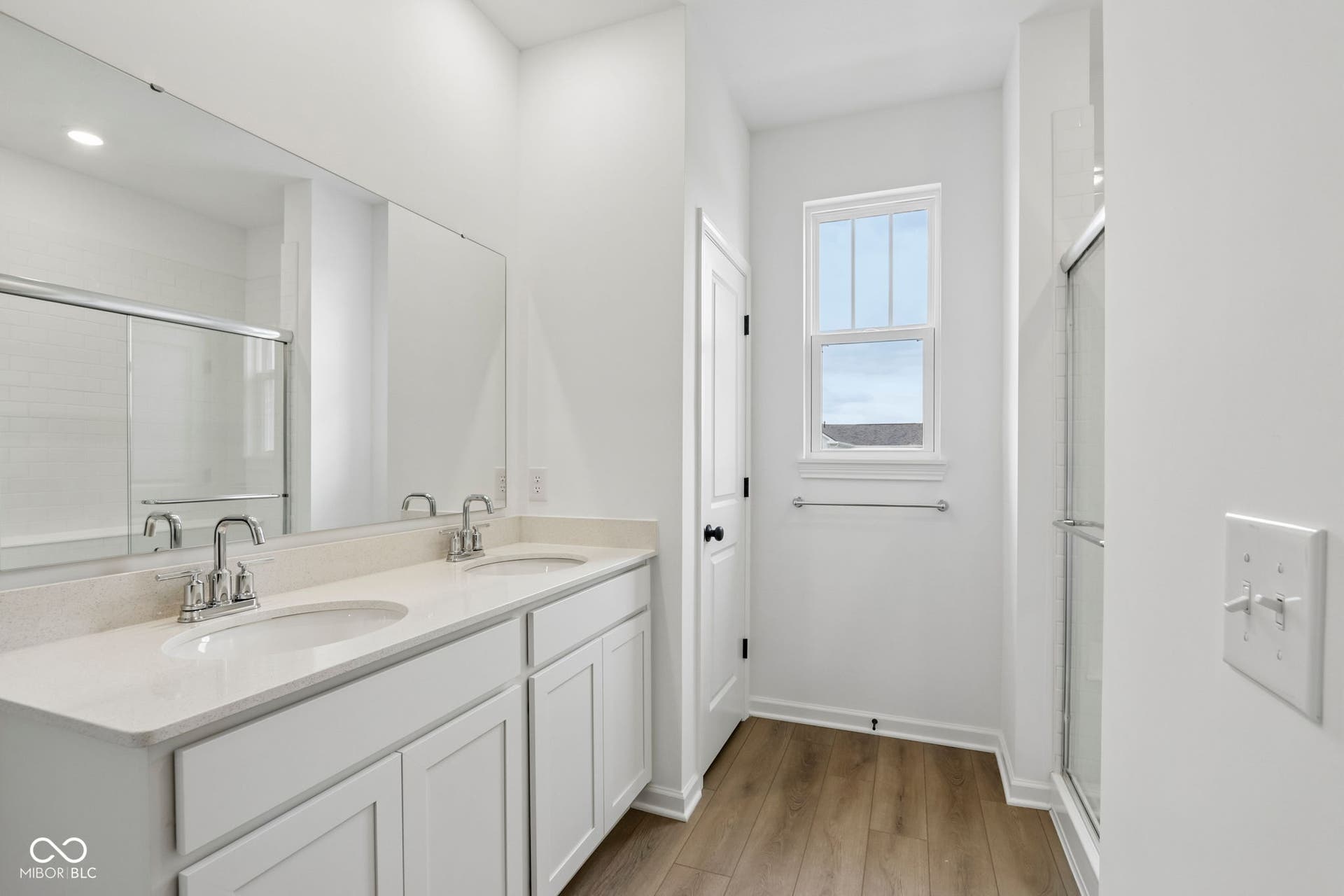 5748 Arcade Boulevard, McCordsville, IN 46055 Bright bathroom featuring a double vanity with stone countertops, individual undermount sinks, and chrome faucets