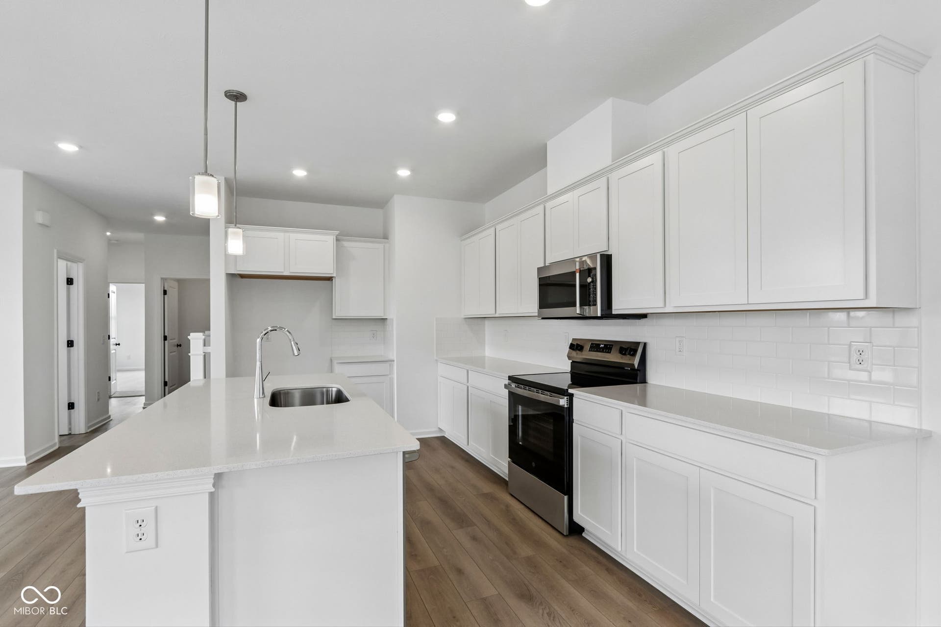 5748 Arcade Boulevard, McCordsville, IN 46055 Bright kitchen featuring a central island with an undermount sink and pendant lighting
