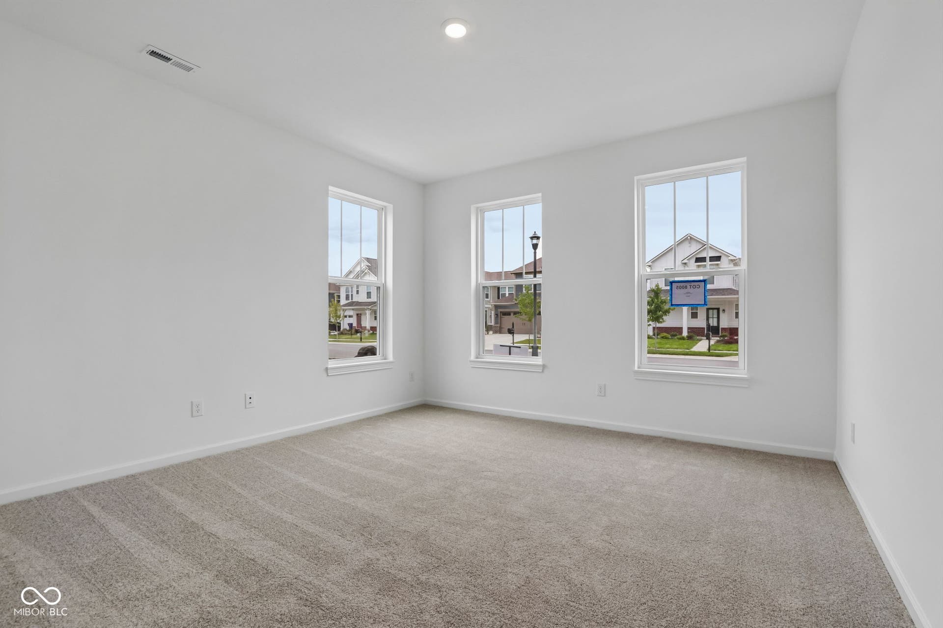 5748 Arcade Boulevard, McCordsville, IN 46055 Bright room featuring three large windows, white walls, light-colored carpet flooring, recessed lighting, and white baseboards