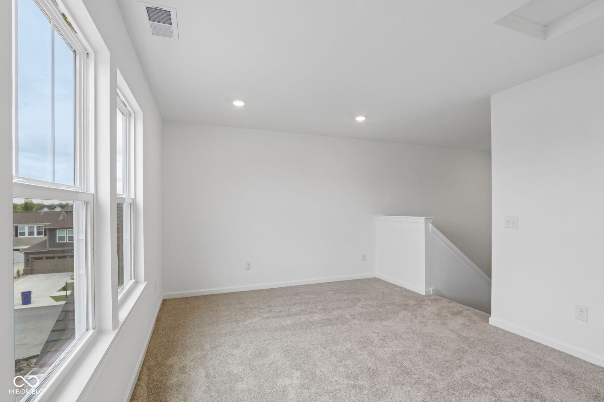 5748 Arcade Boulevard, McCordsville, IN 46055 Carpeted room with recessed lighting and multiple windows