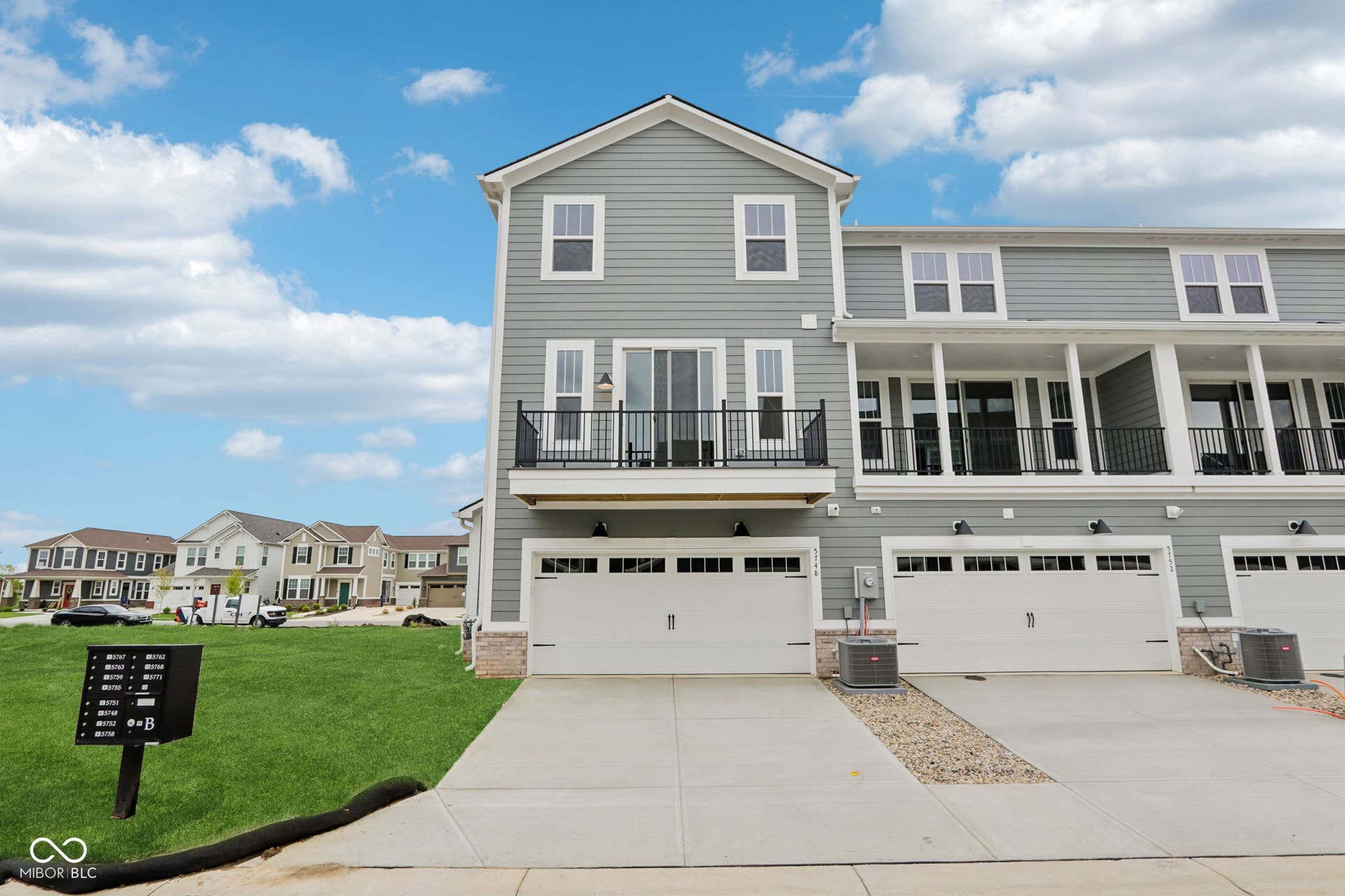 5748 Arcade Boulevard, McCordsville, IN 46055 Contemporary multi-story townhome featuring light gray siding with white trim