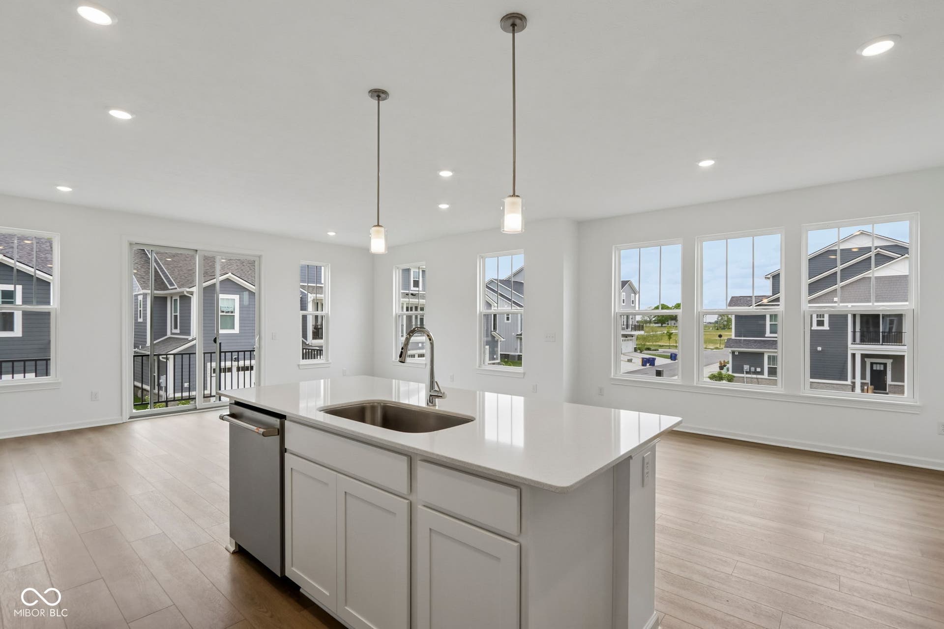 5748 Arcade Boulevard, McCordsville, IN 46055 Open-concept kitchen and living area featuring an island with a stainless steel sink and dishwasher