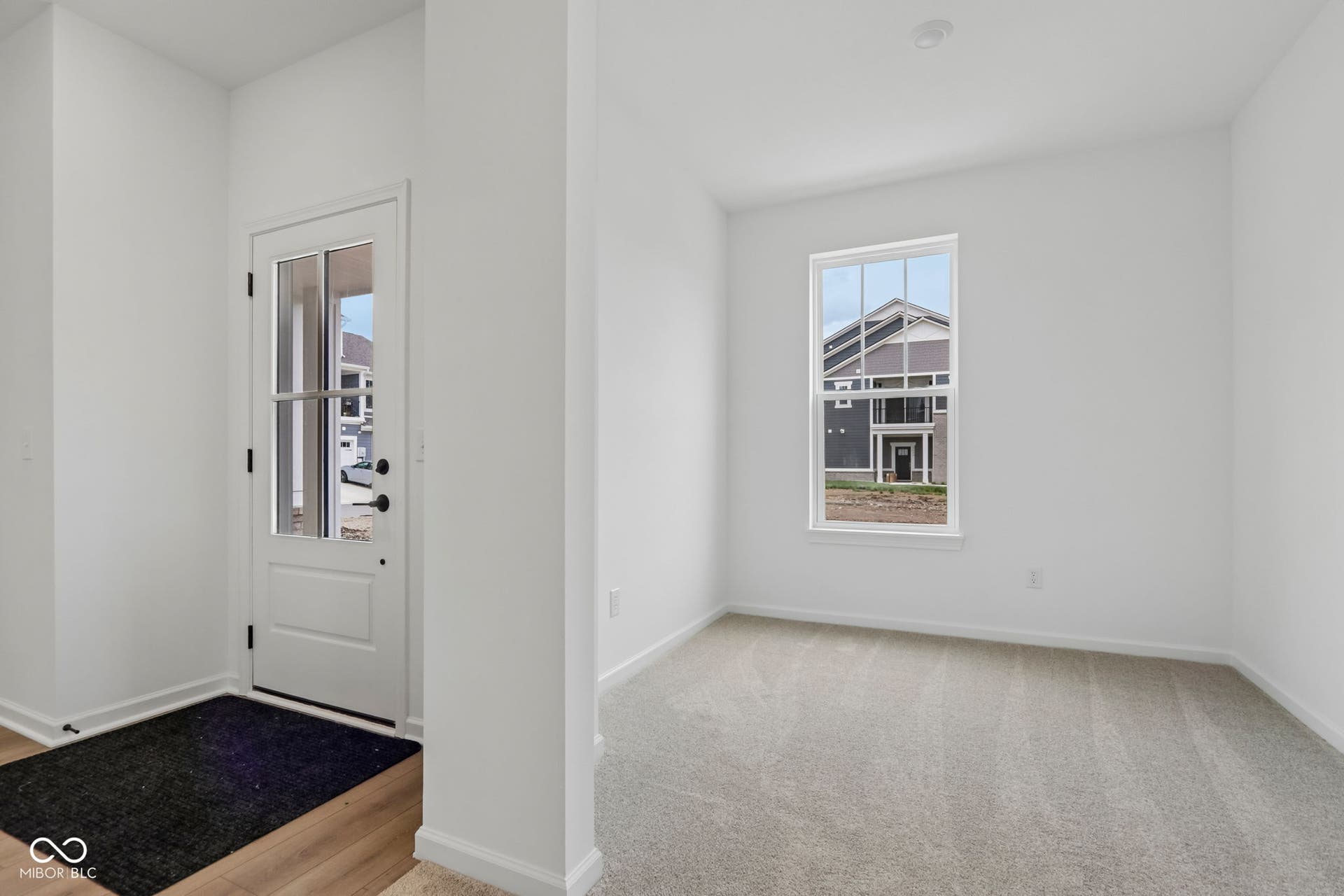 5748 Arcade Boulevard, McCordsville, IN 46055 Entryway featuring a glass-paneled door, wood-finish flooring, and crisp white walls