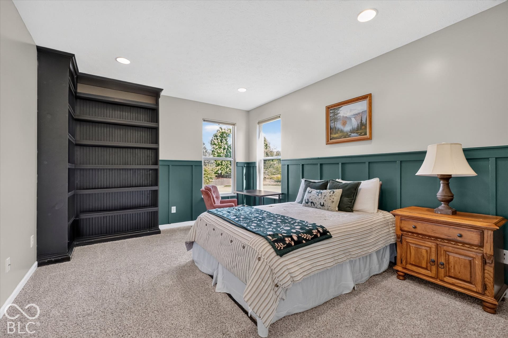 Main floor bedroom with built-in bookshelves