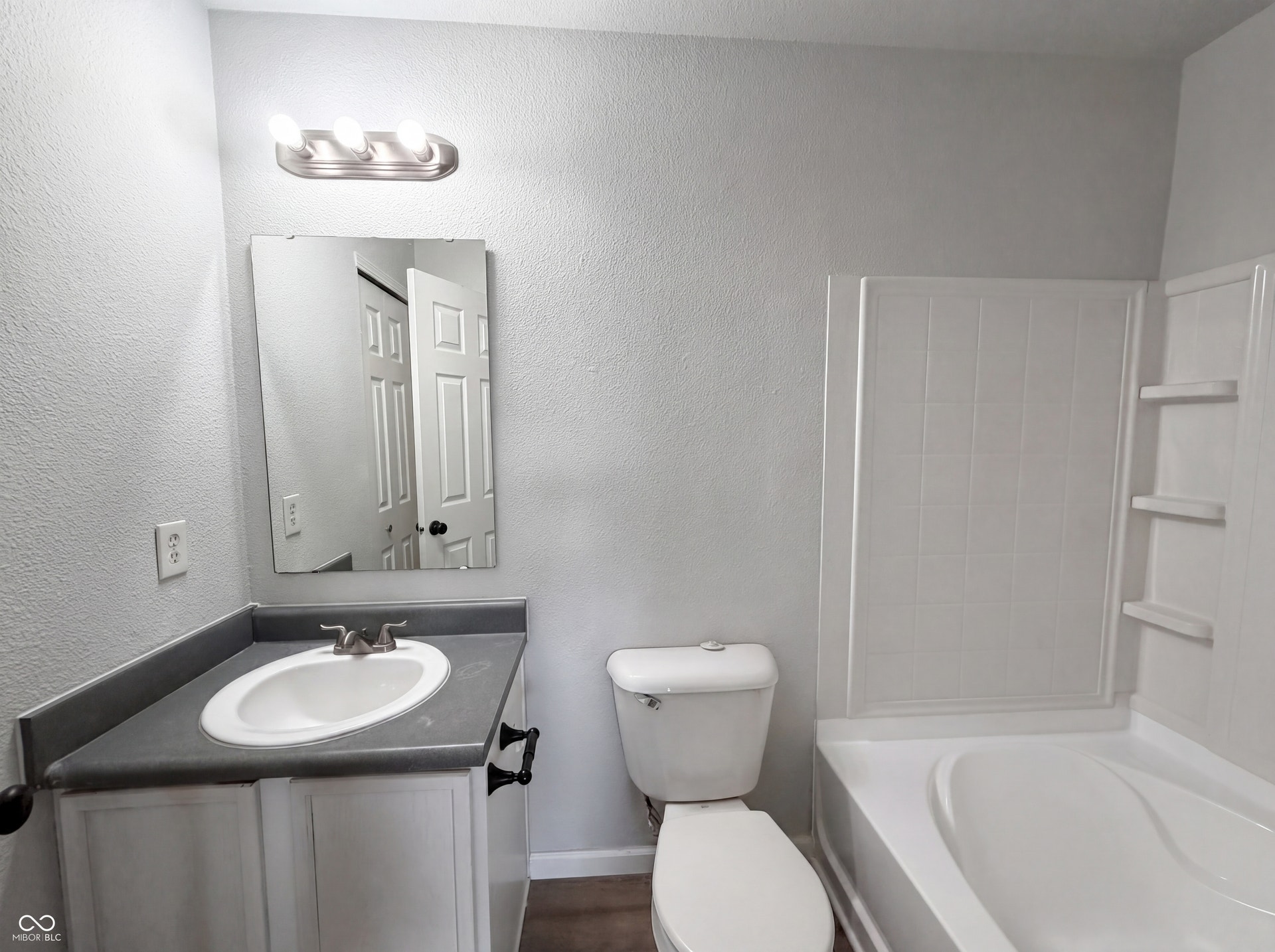 526 Bourneside Drive, Greenfield, IN 46140 Bathroom featuring a white vanity with a gray countertop, an oval undermount sink, and a brushed nickel faucet