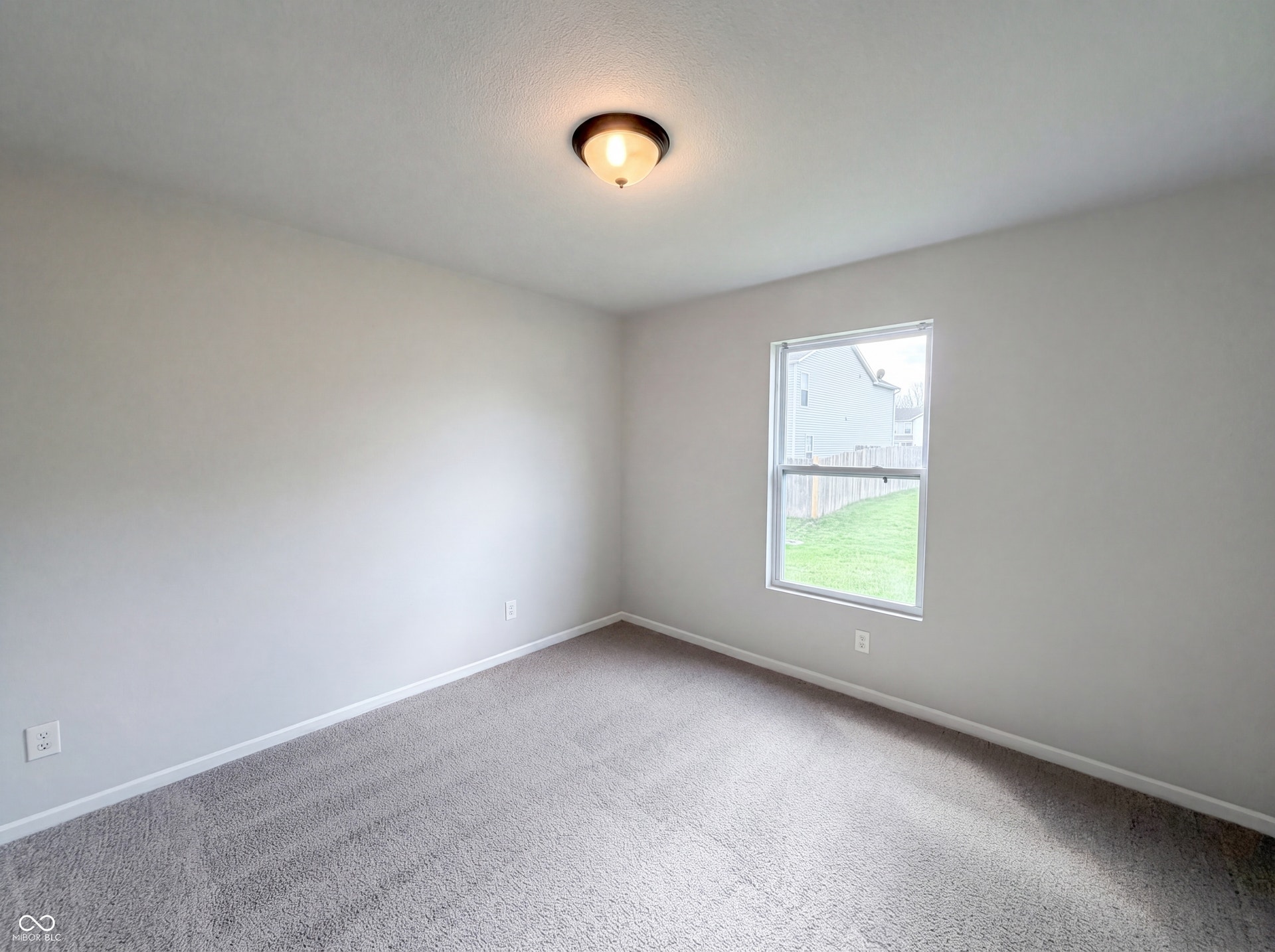 526 Bourneside Drive, Greenfield, IN 46140 Carpeted room featuring a single window, white trim, and a ceiling-mounted light fixture