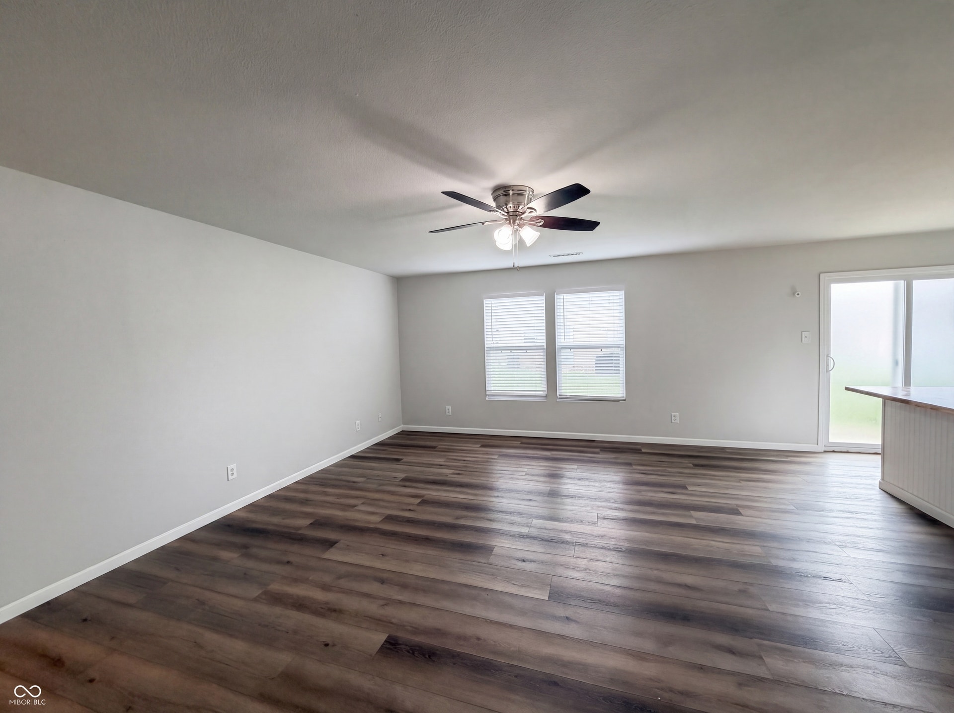 526 Bourneside Drive, Greenfield, IN 46140 Spacious interior featuring wood-finish flooring, light-toned walls, and a ceiling fan with integrated lighting