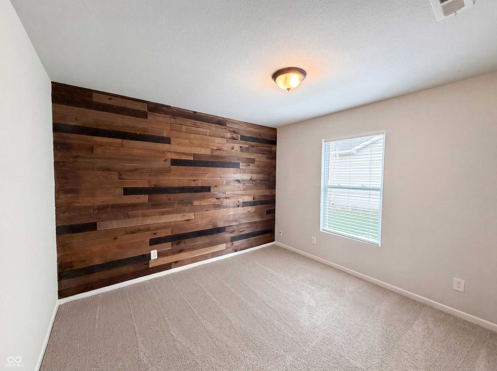 526 Bourneside Drive, Greenfield, IN 46140 Accent wall featuring varied wood plank paneling
