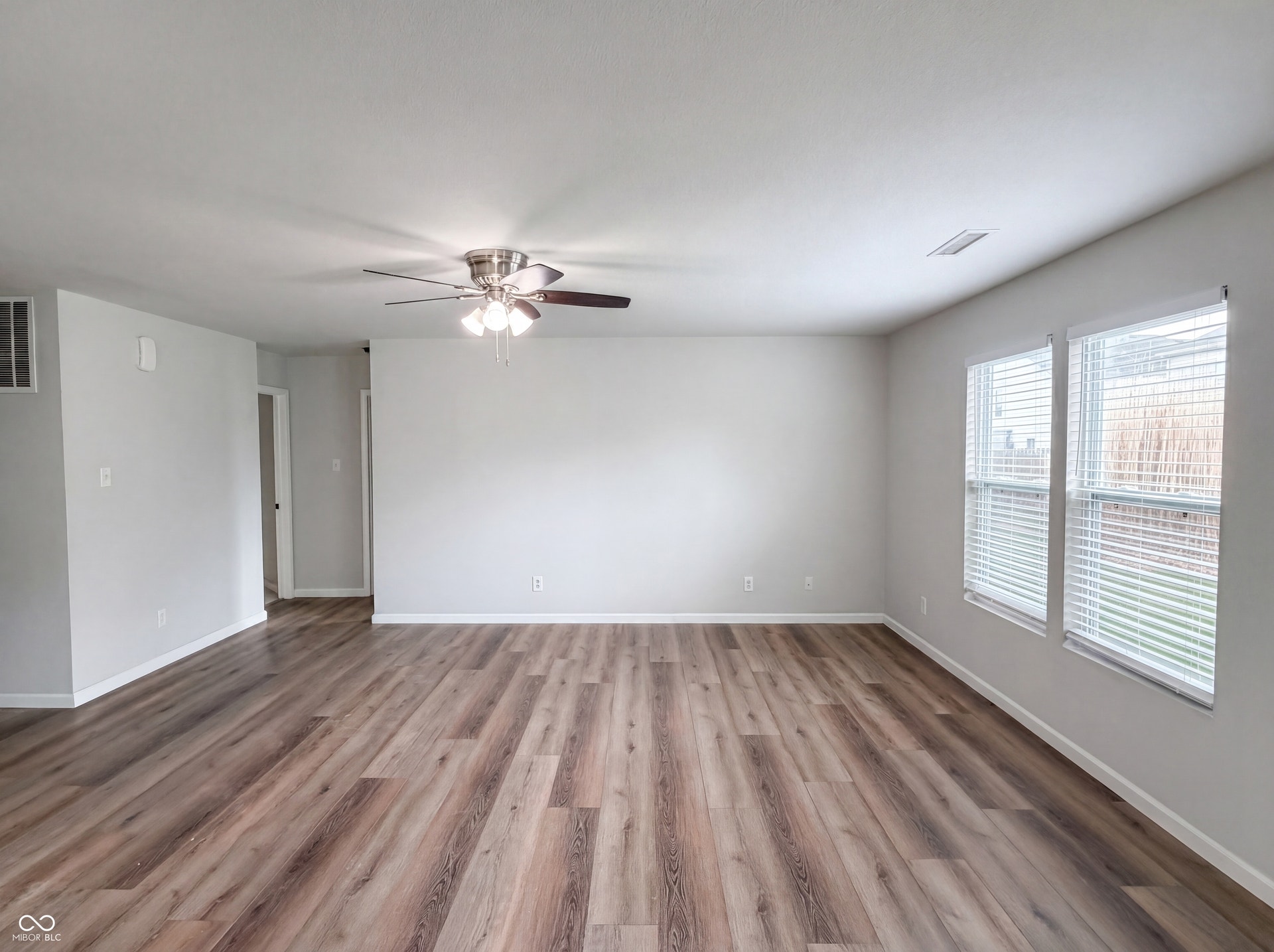 526 Bourneside Drive, Greenfield, IN 46140 Spacious interior featuring wood-finish flooring, light grey wall paint, and white baseboards