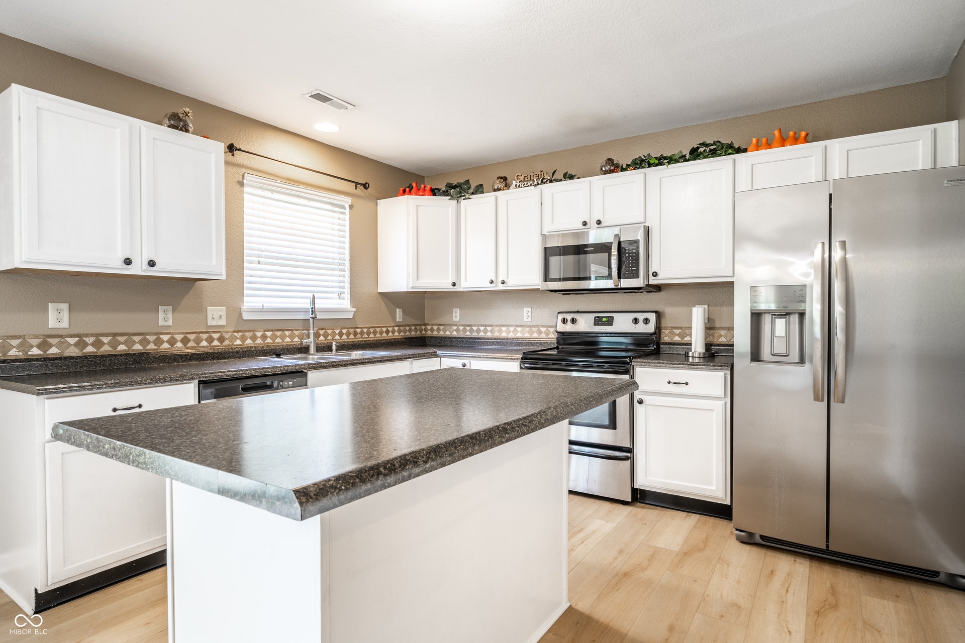 Convenient Island, separate pantry, stainless steel appliances.
