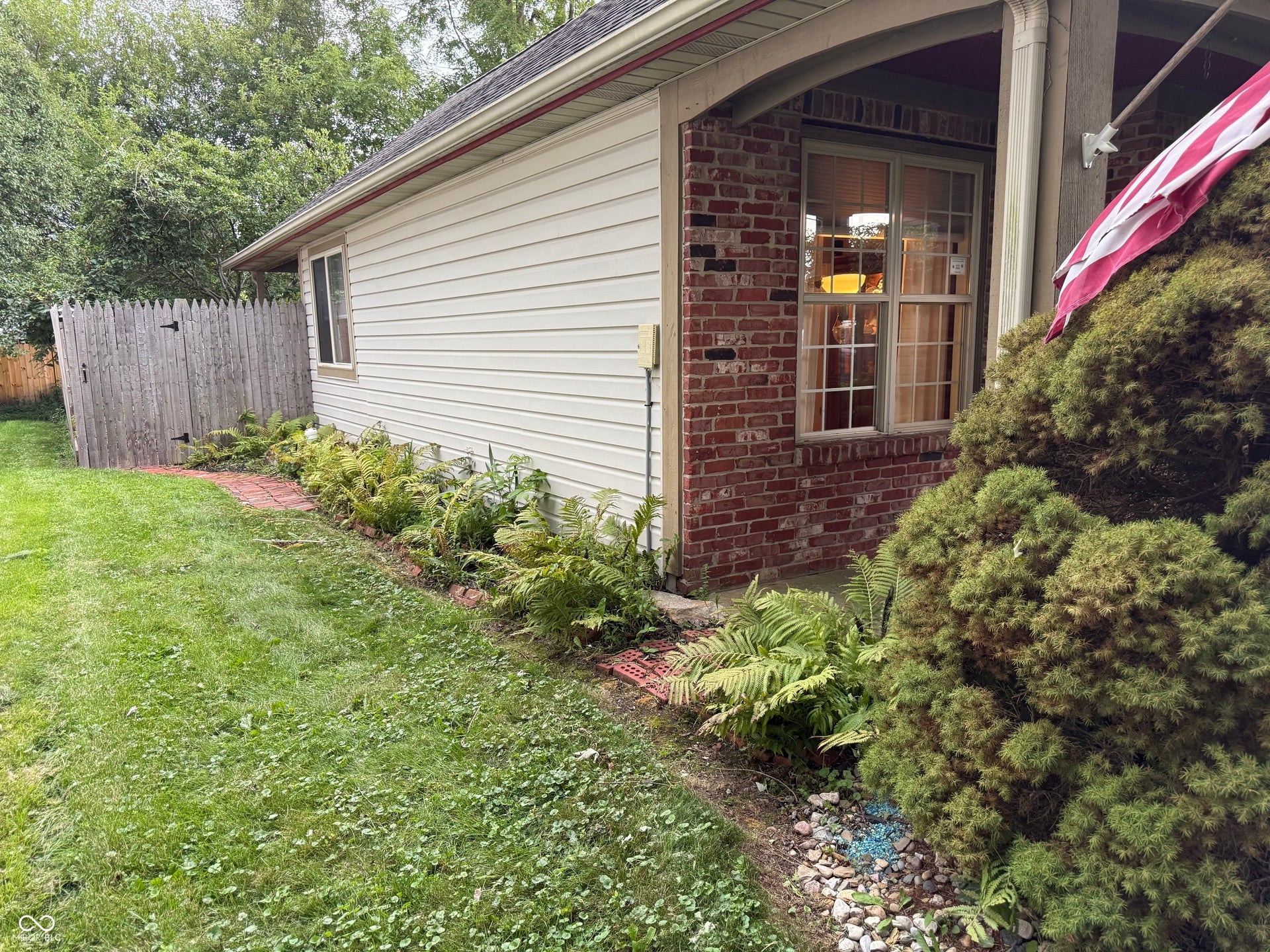 2117 Witt Road, Lebanon, IN 46052 Exterior featuring brick and siding finishes, a window with muntins, and mature landscaping