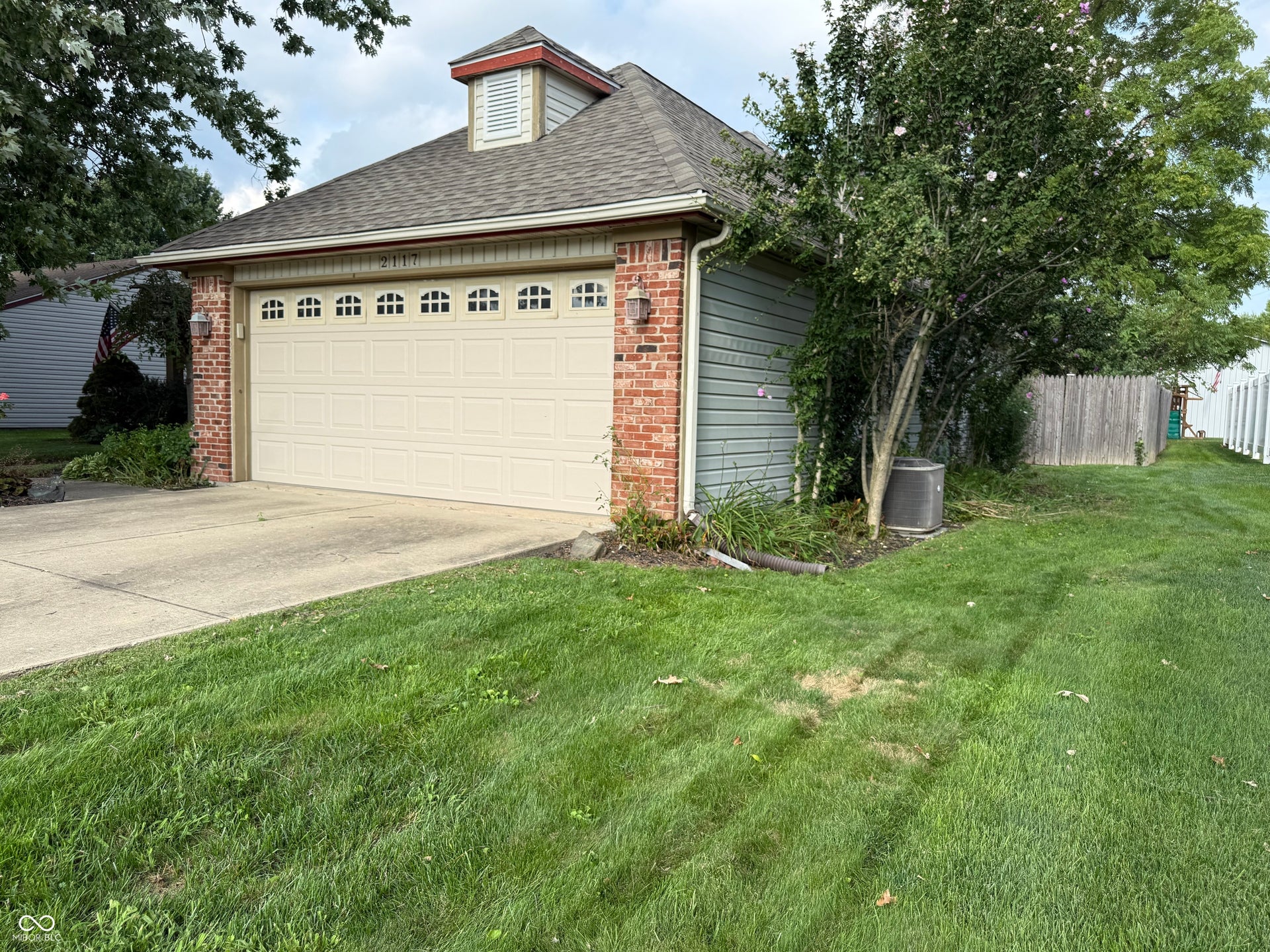 2117 Witt Road, Lebanon, IN 46052 Brick exterior with siding accents, attached garage with decorative windows, and a dormer feature