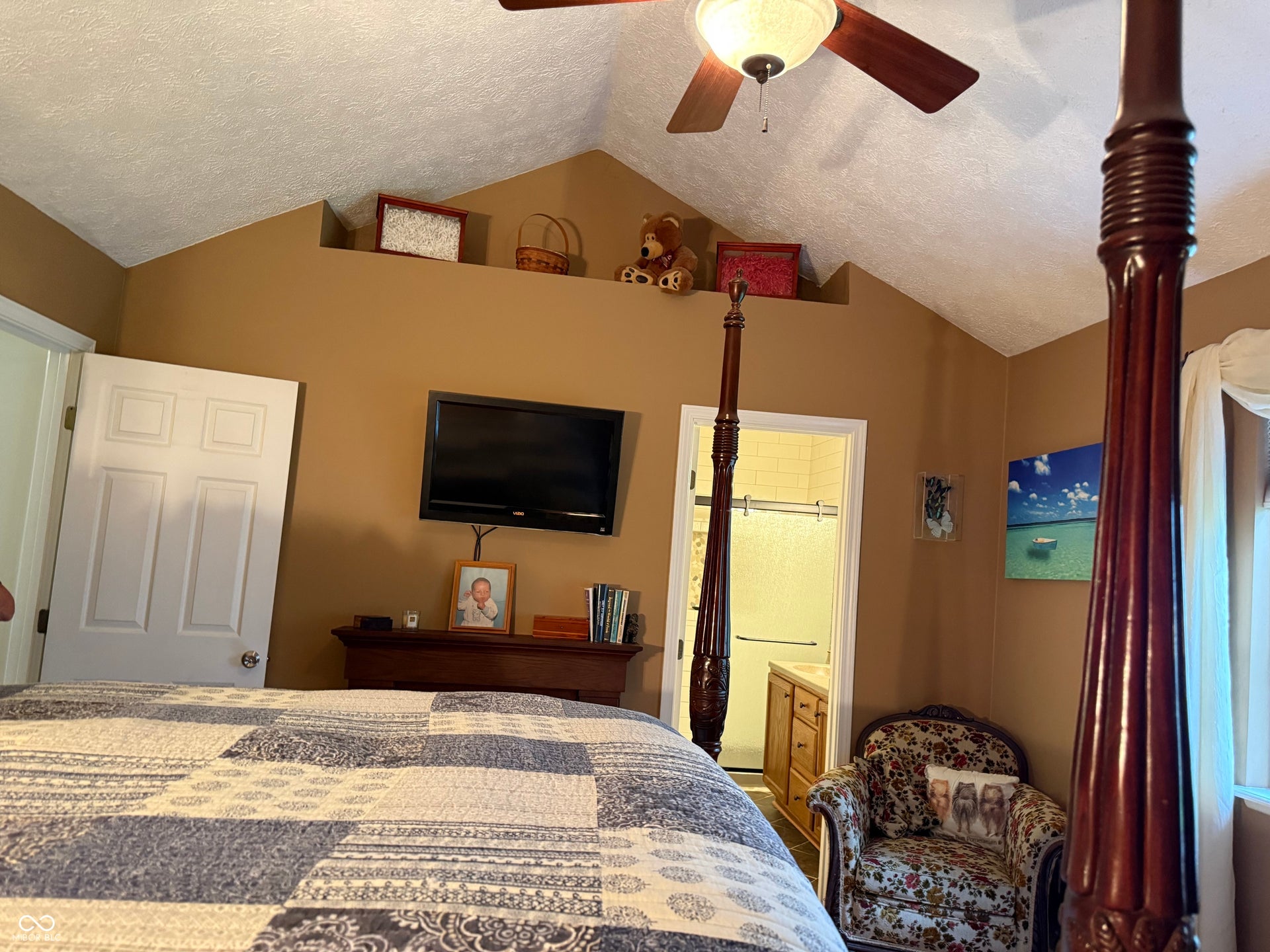 2117 Witt Road, Lebanon, IN 46052 Vaulted ceiling with a ceiling fan, wall-mounted television, and an integrated display shelf