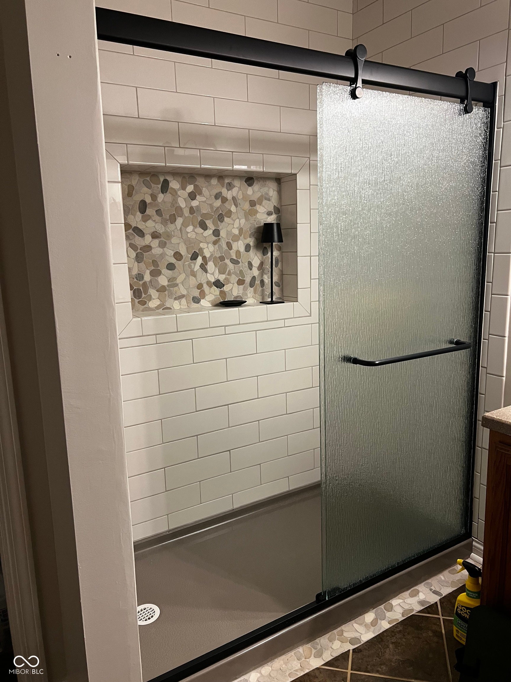 2117 Witt Road, Lebanon, IN 46052 White subway tile shower with a built-in niche featuring pebble mosaic tile