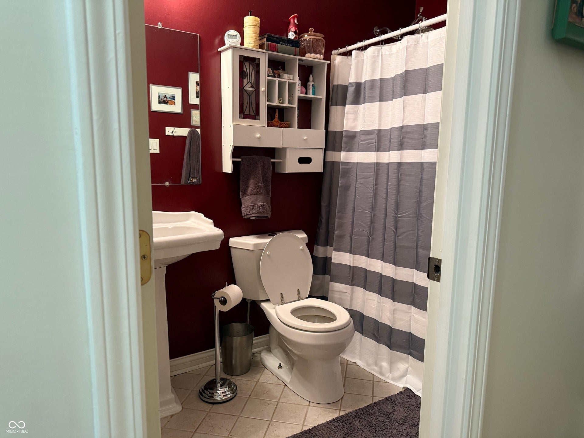 2117 Witt Road, Lebanon, IN 46052 Pedestal sink, wall-mounted mirror, and tile flooring