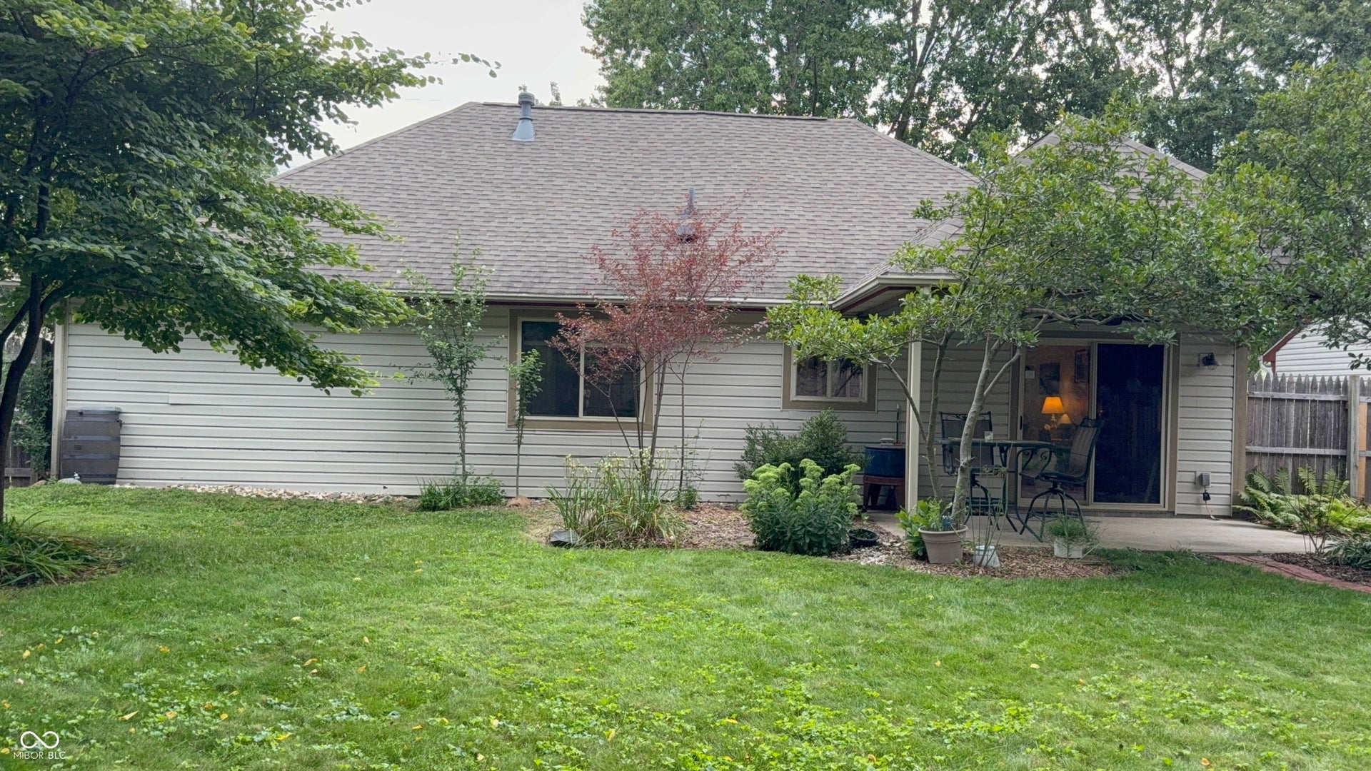 2117 Witt Road, Lebanon, IN 46052 Expansive backyard featuring a manicured lawn, established landscaping, and a patio area