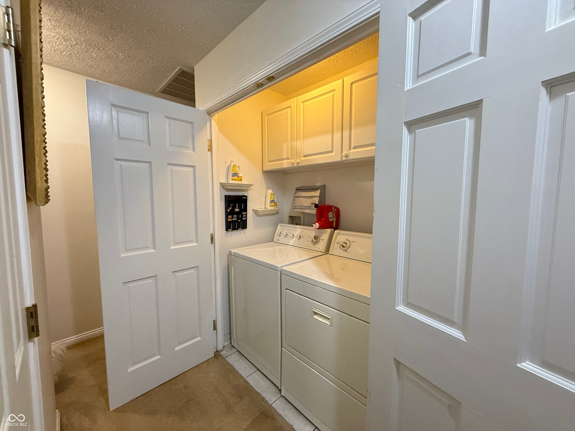 2117 Witt Road, Lebanon, IN 46052 Laundry area featuring upper cabinetry, a utility shelf, and tile flooring