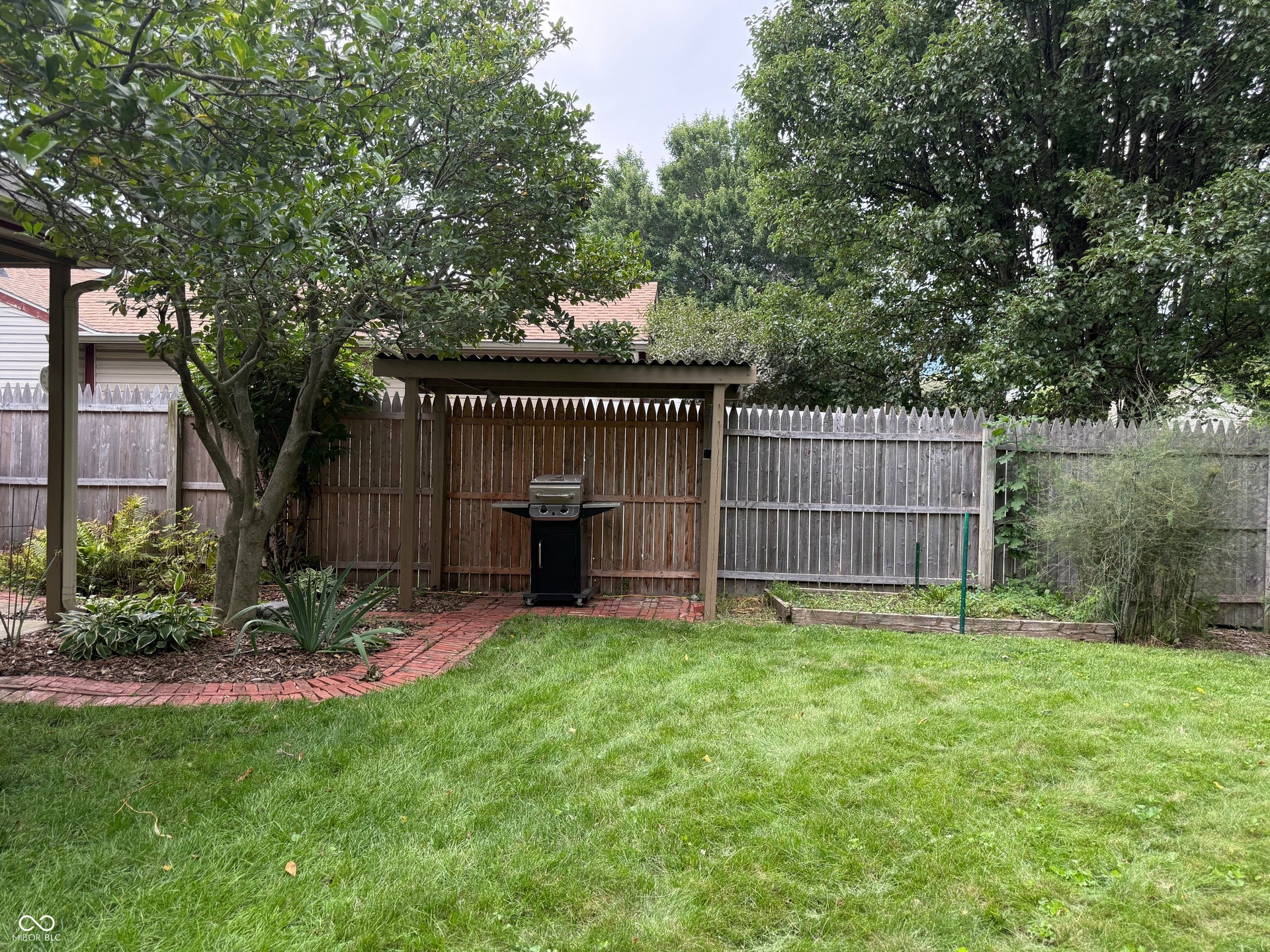 2117 Witt Road, Lebanon, IN 46052 Expansive green lawn with mature trees and a privacy fence