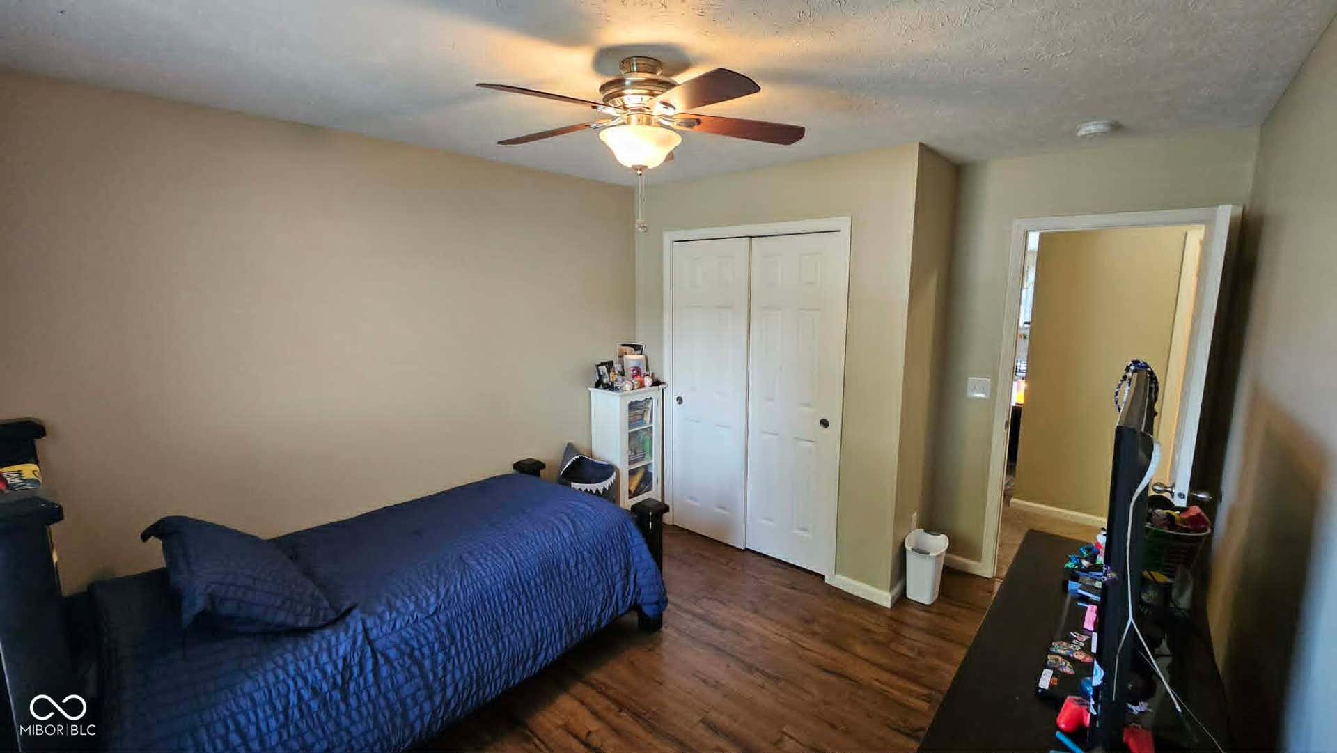 Room featuring wood-finish flooring and neutral wall tones