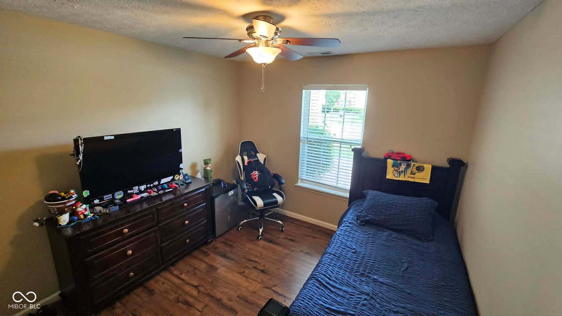Bedroom Room featuring wood-finish flooring, neutral wall tones, and a ceiling fan with integrated lighting could also be used as office.