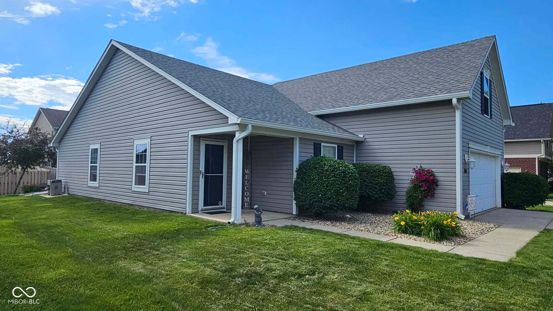 Gray horizontal siding exterior with a dark shingle roof