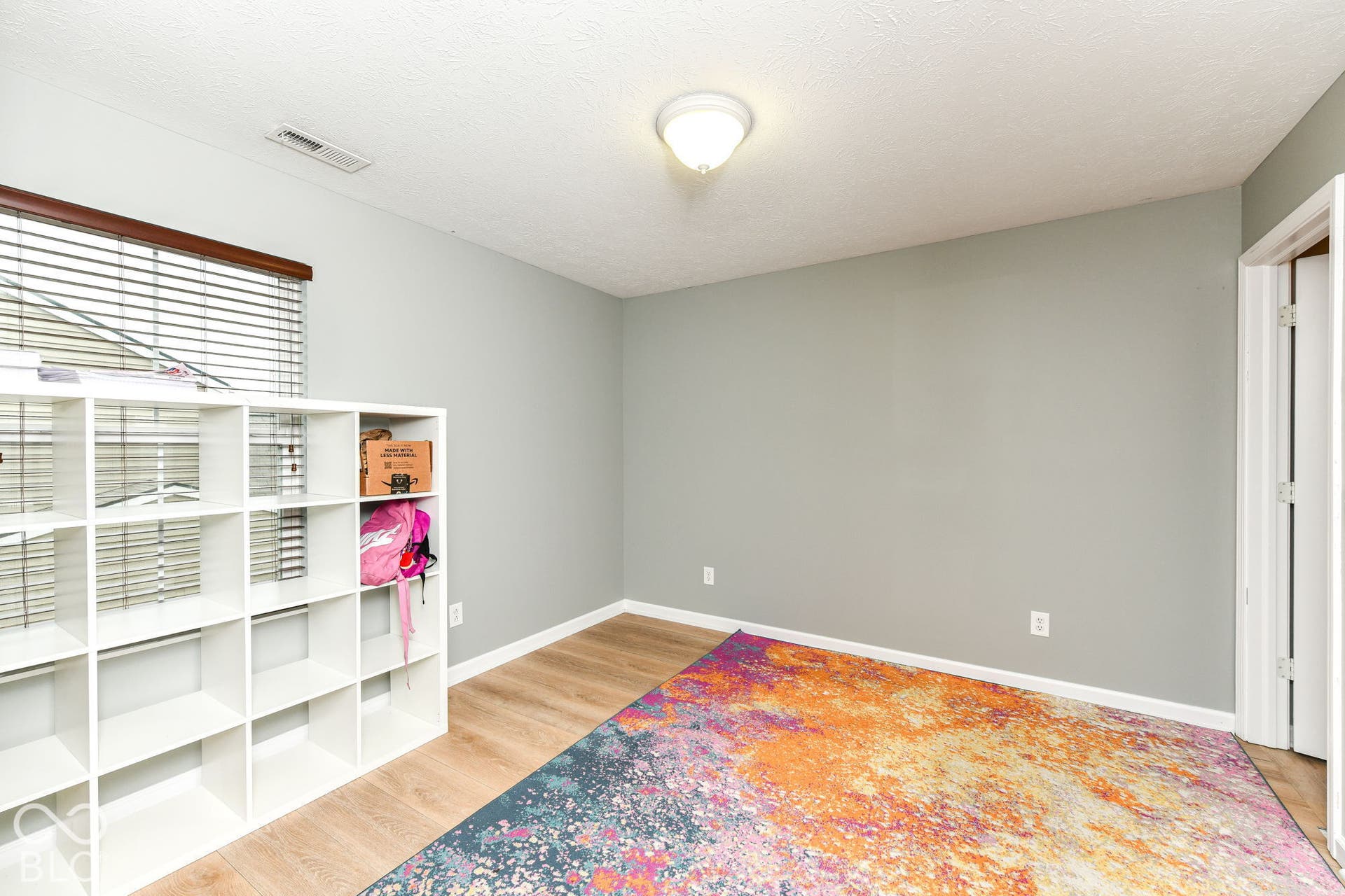 Room with neutral wall color and wood-finish flooring
